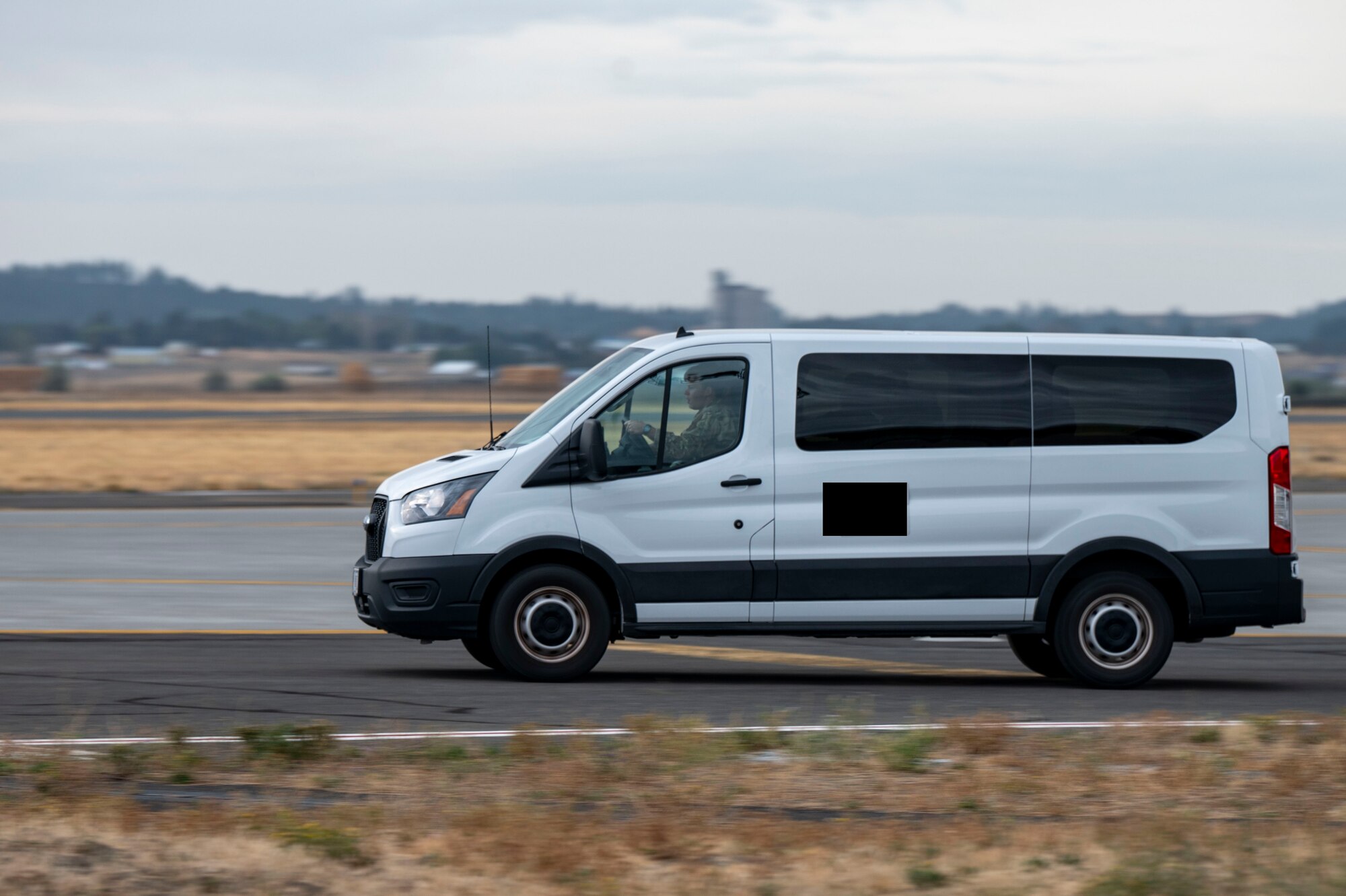 A van drives on the flightline.