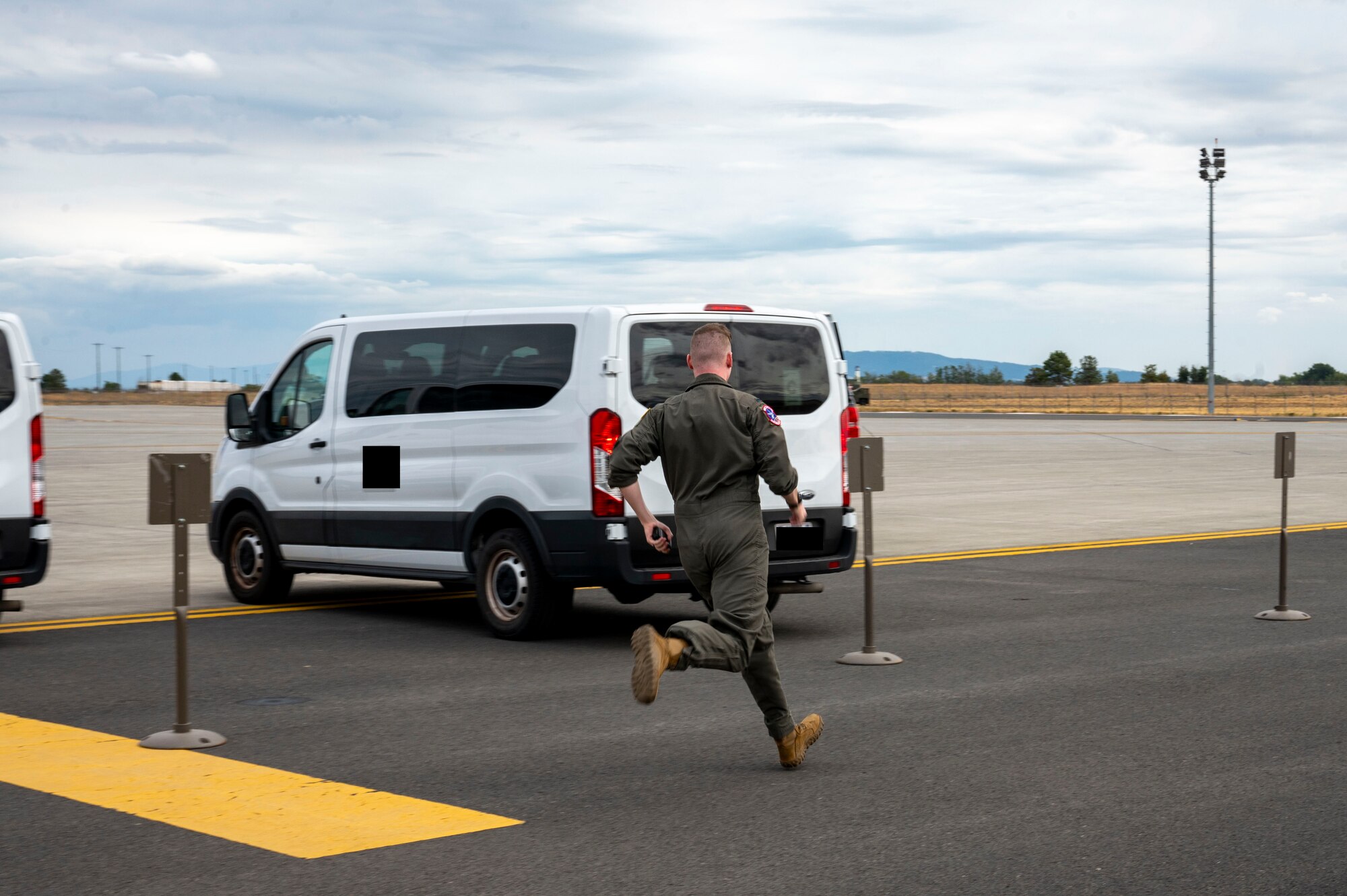 An Airman runs to a van.