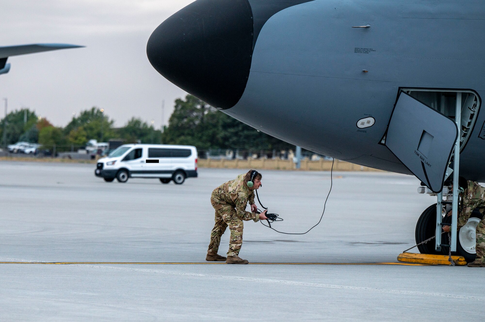 An airman works on a jet.