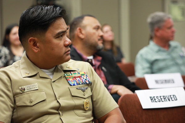 Naval Medical Forces Pacific Command Master Chief Jerry Cantorna listens to Rear Adm. Guido Valdes, commander of NMFP and director of Defense Health Network Pacific Rim, along with more than 40 audiences and about 120 more joining via live stream, as Valdes shared how his Hispanic heritage, shaped by values of family, faith, and language, influenced his Naval career and leadership in Navy Medicine during the Naval Air Warfare Center Weapons Division’s 2024 Hispanic Heritage Observance, Sep. 10. (Navy photo by Arsenio R. Cortez Jr.)