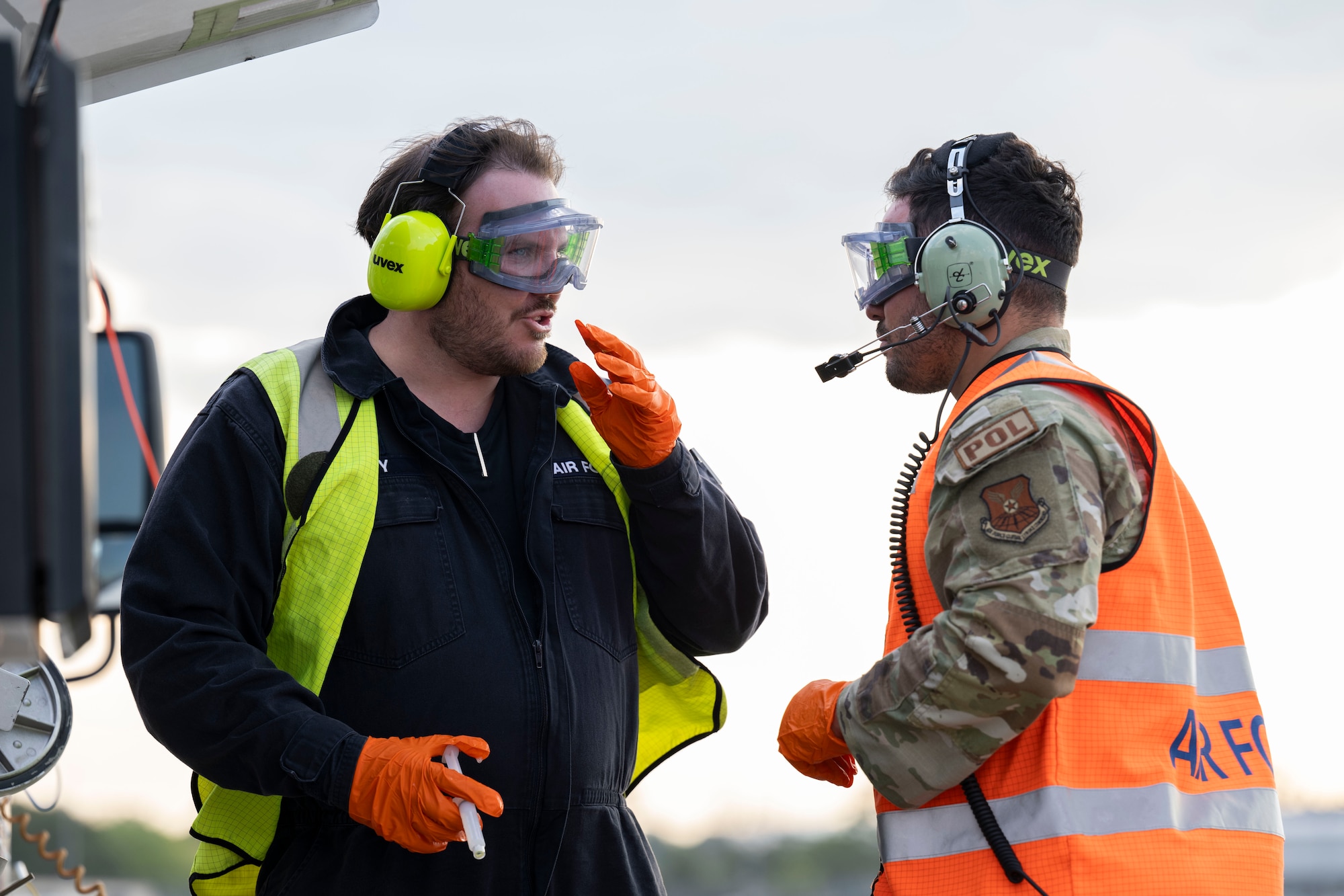 Royal Australian Air Force LAC Sean Henry Duddy, No. 23 Squadron aviation fuel operator, left,  talks with U.S. Air Force Senior Airman Christopher Rodriguez, 110th Expeditionary Bomb Squadron fuels service center supervisor, during hot pit operations with a U.S. Air Force B-2 Spirit stealth bomber during a Bomber Task Force mission at Royal Australian Air Force Base Amberley, Australia, Sept. 9, 2024. The U.S. seeks every opportunity to train alongside its allies and partners to build interoperability and bolster our collective ability to support a free and open Indo-Pacific. (U.S. Air Force photo by Tech. Sgt. Anthony Hetlage)