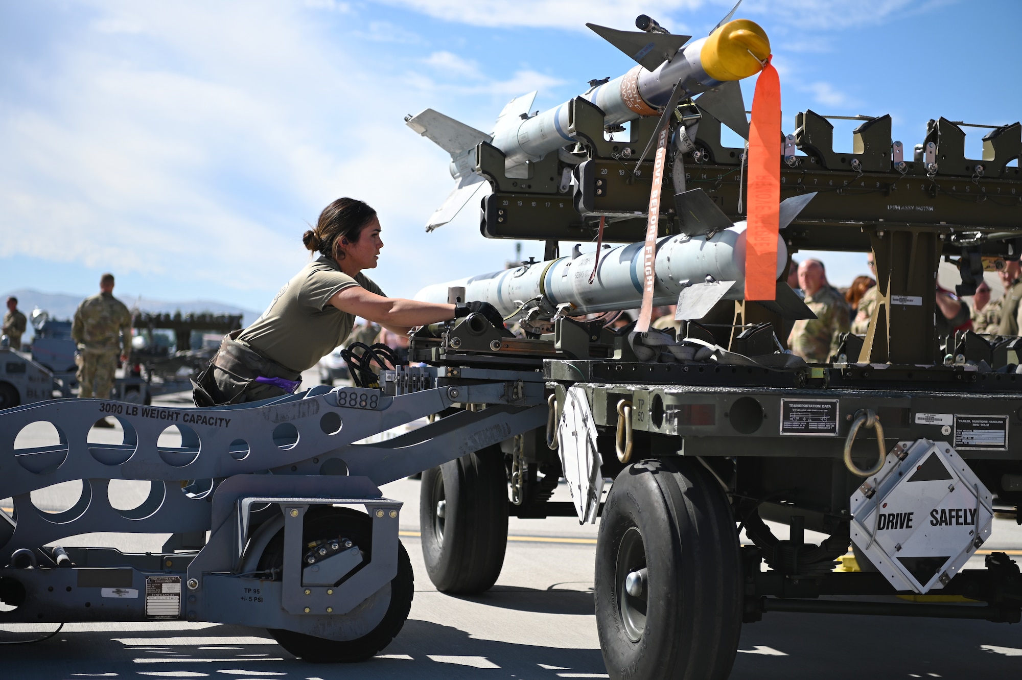 U.S. Air Force Tech. Sgt. Ashley Vela, 173rd Aircraft Maintenance Squadron weapons load crew chief, utilizes an MJU-1 jammer to load a missile.