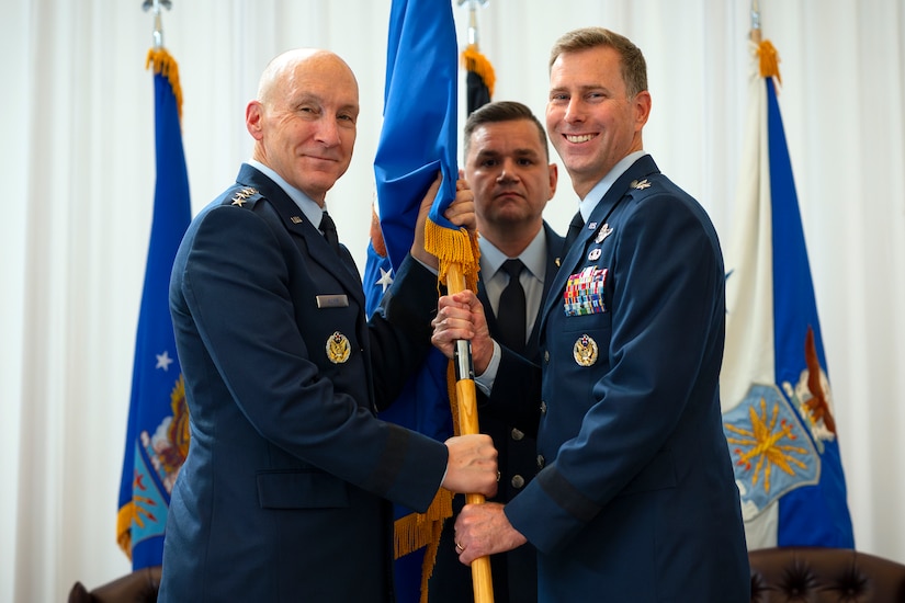 Maj. Gen. David Mineau, right, accepts a guidon from U.S. Air Force Chief of Staff Gen. David Allvin, left, during a Change of Command ceremony at Davis-Monthan Air Force Base, Arizona, Sep. 11, 2024. At the direction of the Secretary of the Air Force, Air Forces Southern was elevated to a Service Component Command.  The Air Force is organizing its major commands, or MAJCOMs, into Institutional Commands, responsible for organizing, training, and equipping Airmen, and Service Component Commands, responsible for preparing Airmen for warfighting in a combatant command’s area of responsibility. The changes are part of the Department of the Air Force’s Great Power Competition initiative. (U.S. Air Force photo by Tech. Sgt. Rachel Maxwell)