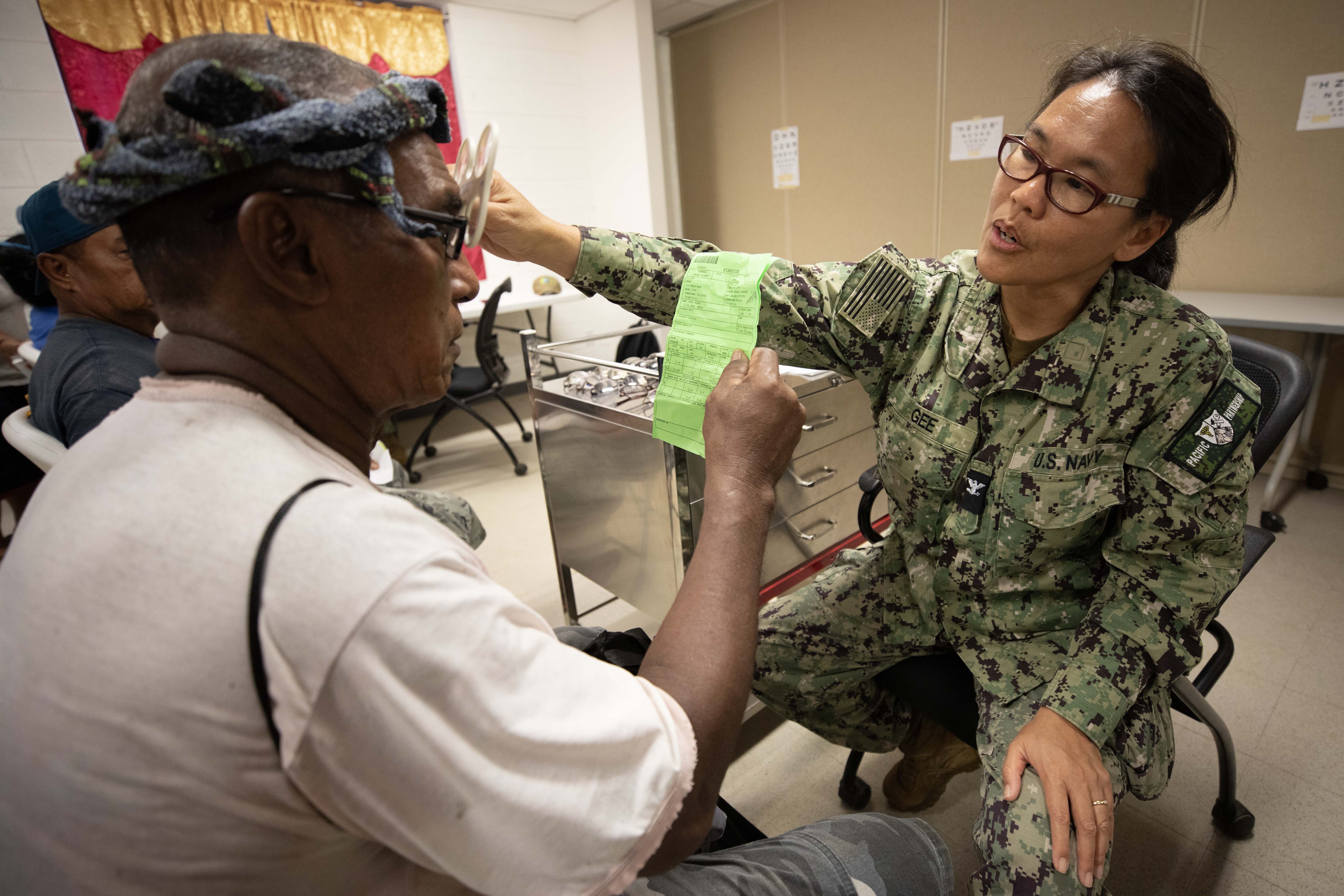 Capt. Sharlene Gee examines a patient for glasses at Yap State Hospital.