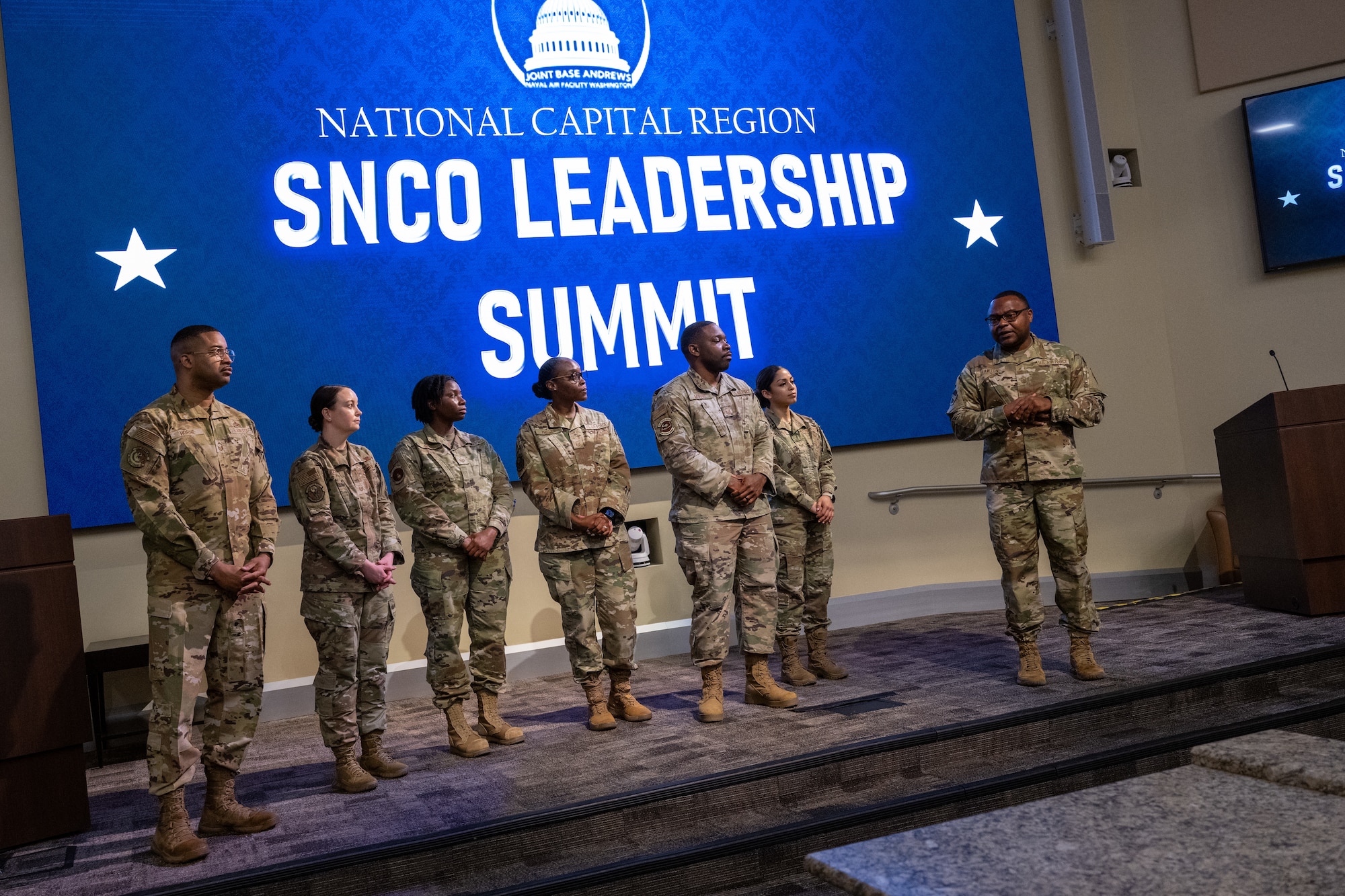 U.S. Air Force Airmen stand for recognition of their contribution to the event coordination of the National Capital Region SNCO Summit at the Smart Center on Joint Base Andrews, Maryland, Sept. 6, 2024. The summit provided an in-depth briefing on the upcoming promotionary rank, outlining the expectations and responsibilities that come with the promotion. (U.S. Air Force photo by Airman 1st Class Shanel Toussaint)
