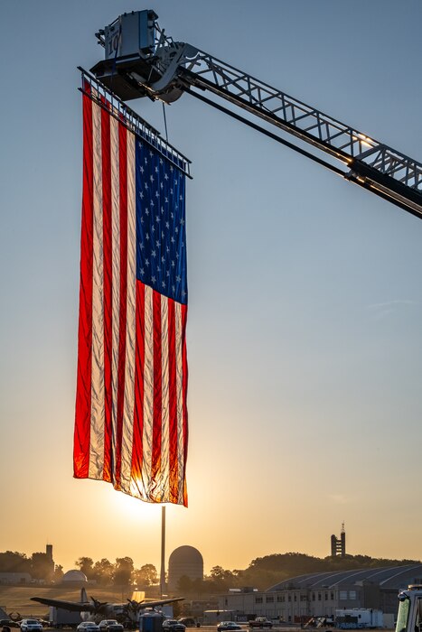 A U.S. flag is illuminated by the golden morning light