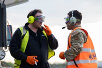 Royal Australian Air Force LAC Sean Henry Duddy, No. 23 Squadron aviation fuel operator, left,  talks with U.S. Air Force Senior Airman Christopher Rodriguez, 110th Expeditionary Bomb Squadron fuels service center supervisor, during hot pit operations with a U.S. Air Force B-2 Spirit stealth bomber during a Bomber Task Force mission at Royal Australian Air Force Base Amberley, Australia, Sept. 9, 2024. The U.S. seeks every opportunity to train alongside its allies and partners to build interoperability and bolster our collective ability to support a free and open Indo-Pacific. (U.S. Air Force photo by Tech. Sgt. Anthony Hetlage)