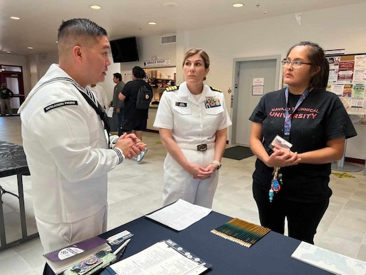 Aviation Boatswain’s Mate (Equipment) 1st Class Isiah Lizama, a recruiter with Navy Talent Acquisition Group (NTAG) Phoenix, and Capt. Shauna O’Sullivan, a rheumatologist and Navy Medical Corps career planner at U.S. Navy Bureau of Medicine and Surgery (BUMED) and a 1998 graduate of the University of New Mexico, speaks with a student at the Navajo Technical University (NTU) during Albuquerque Navy Week, Sept. 13.