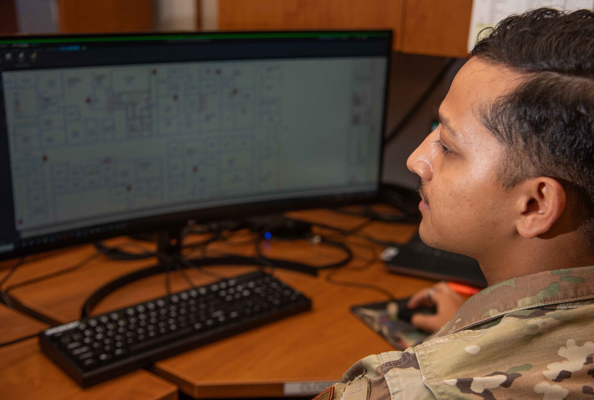 A1C Sanjay Budhathoki, 4th CES engineering journeyman, labels and marks a building floor plan.