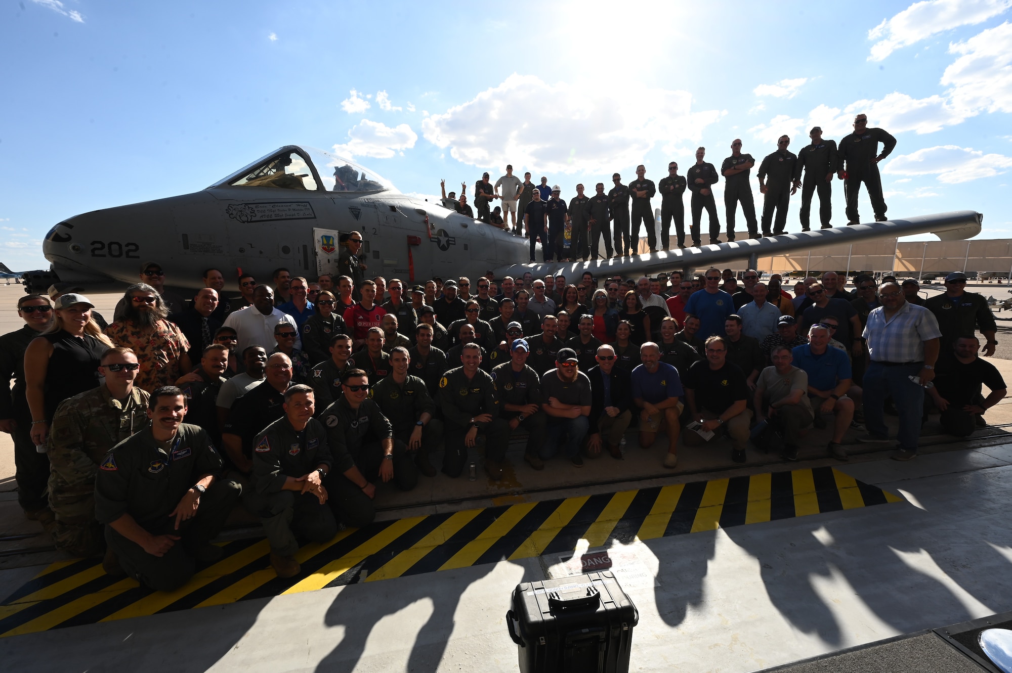 Past and present members of the 354th Fighter Squadron pose for a group photo during the 354th FS inactivation ceremony at Davis-Monthan Air Force Base, Arizona, Sept. 13, 2024. The A-10 Thunderbolt II aircraft was the last Air Force fixed-wing aircraft that was dedicated to the Combat Search and Rescue mission. (U.S. Air Force photo by Staff Sgt. Abbey Rieves)