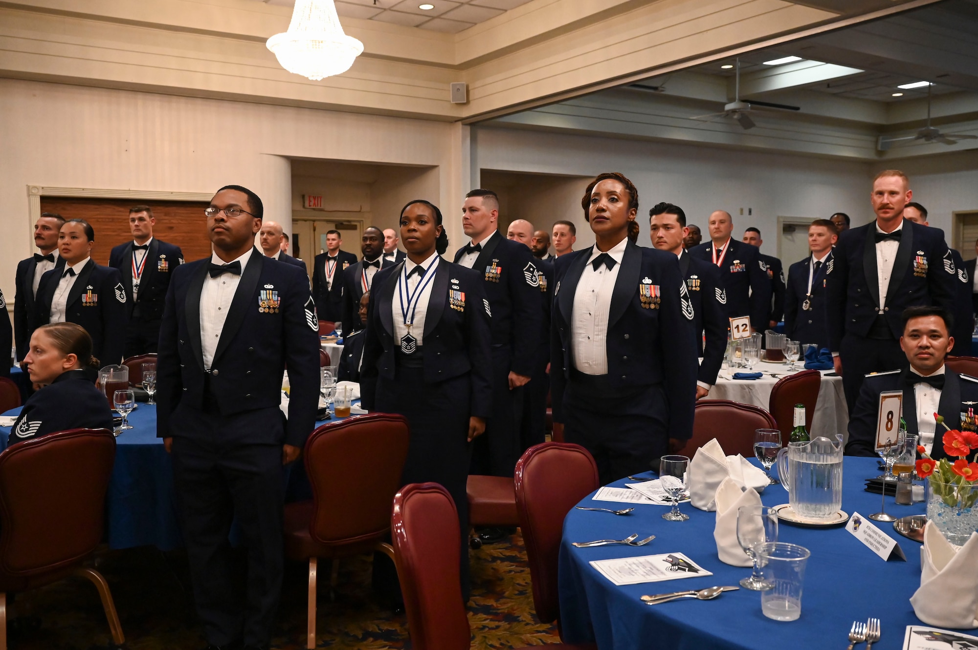 U.S. Air Force senior noncommissioned officer inductees stand at attention during the reading of the SNCO Charge during an SNCO induction ceremony.