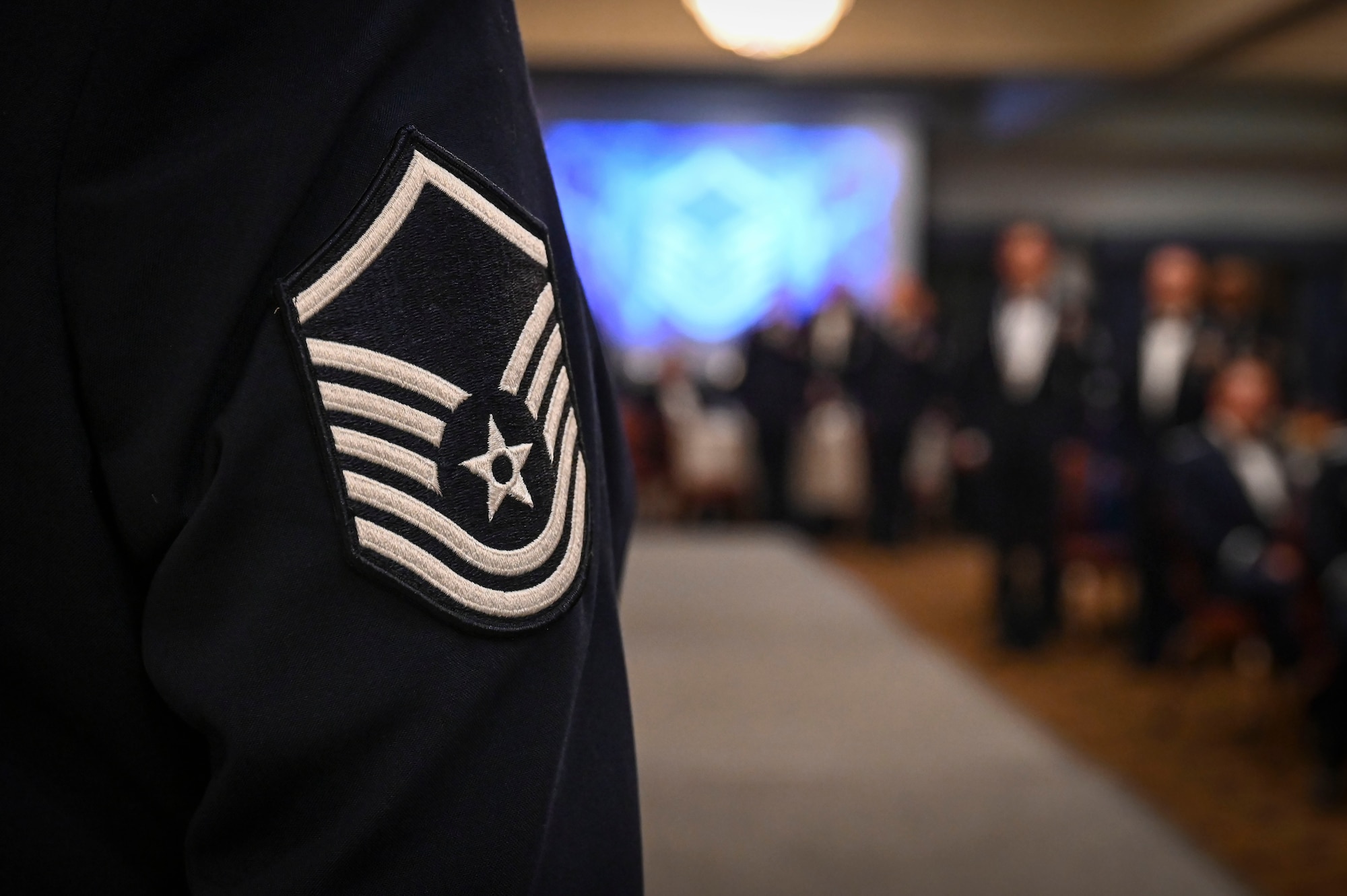U.S. Air Force senior noncommissioned officer inductees stand at attention during the reading of the SNCO Charge during an SNCO induction ceremony