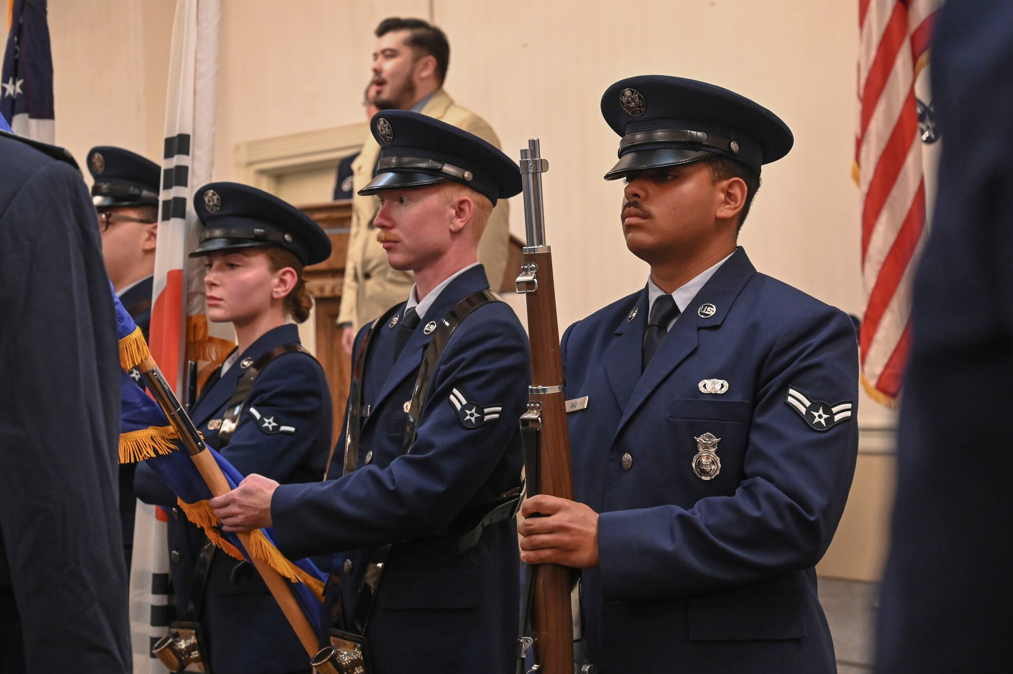 The base honor guard presents colors during an SNCO induction ceremony.
