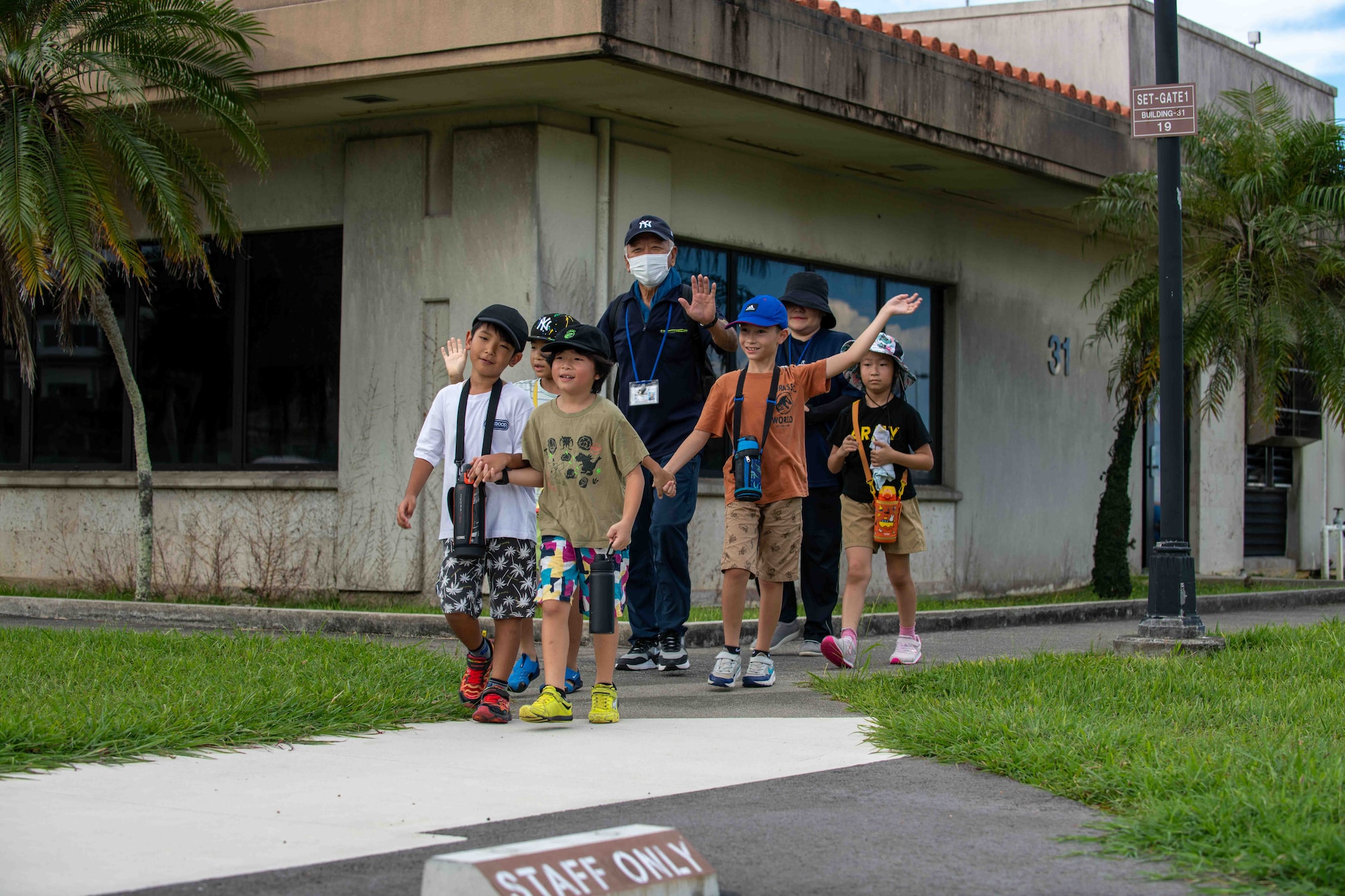 Japanese locals walk onto Kadena Base waving