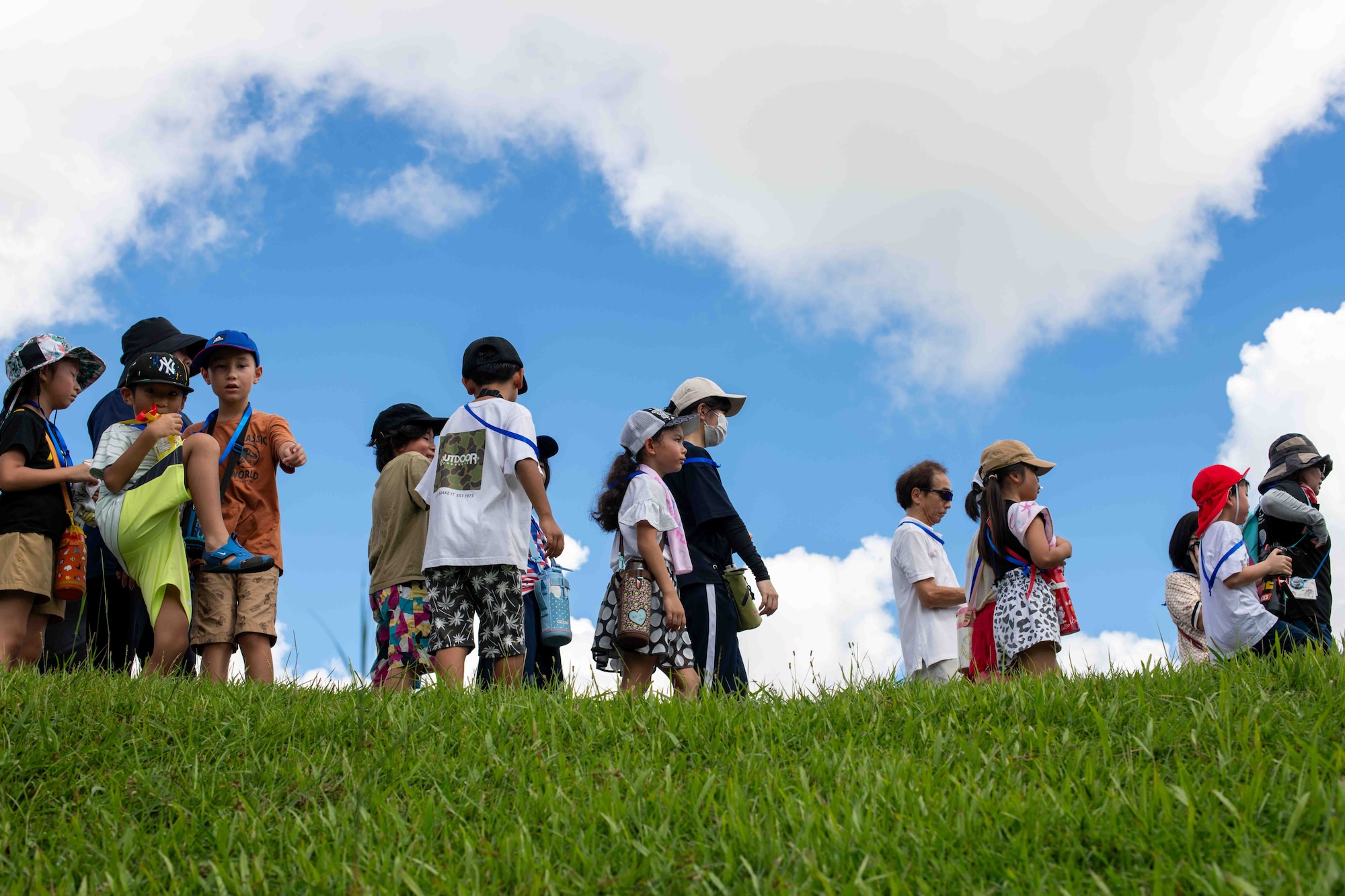 Japanese locals and children walk on grass