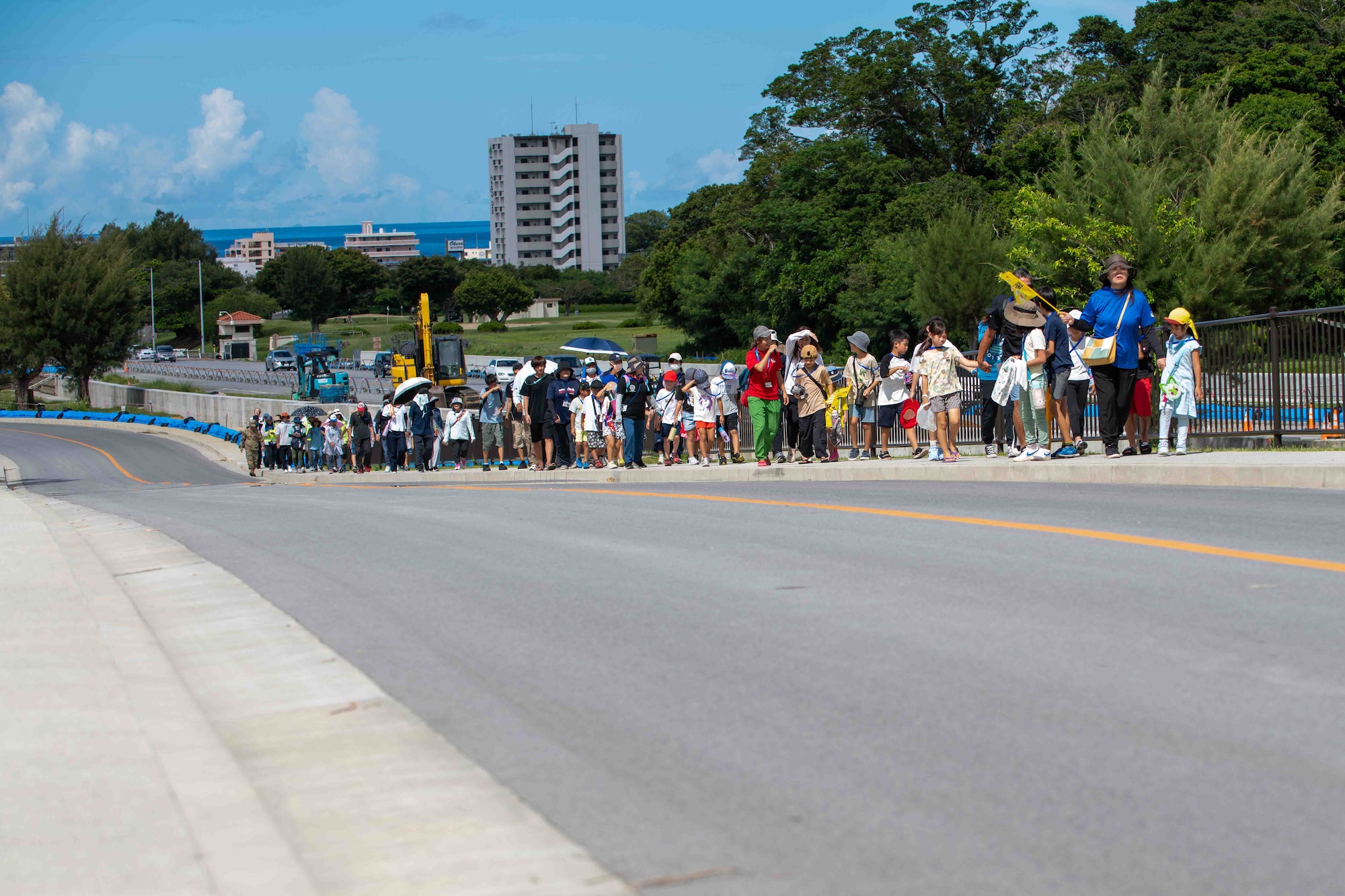 Japanese locals walk in a group to higher ground
