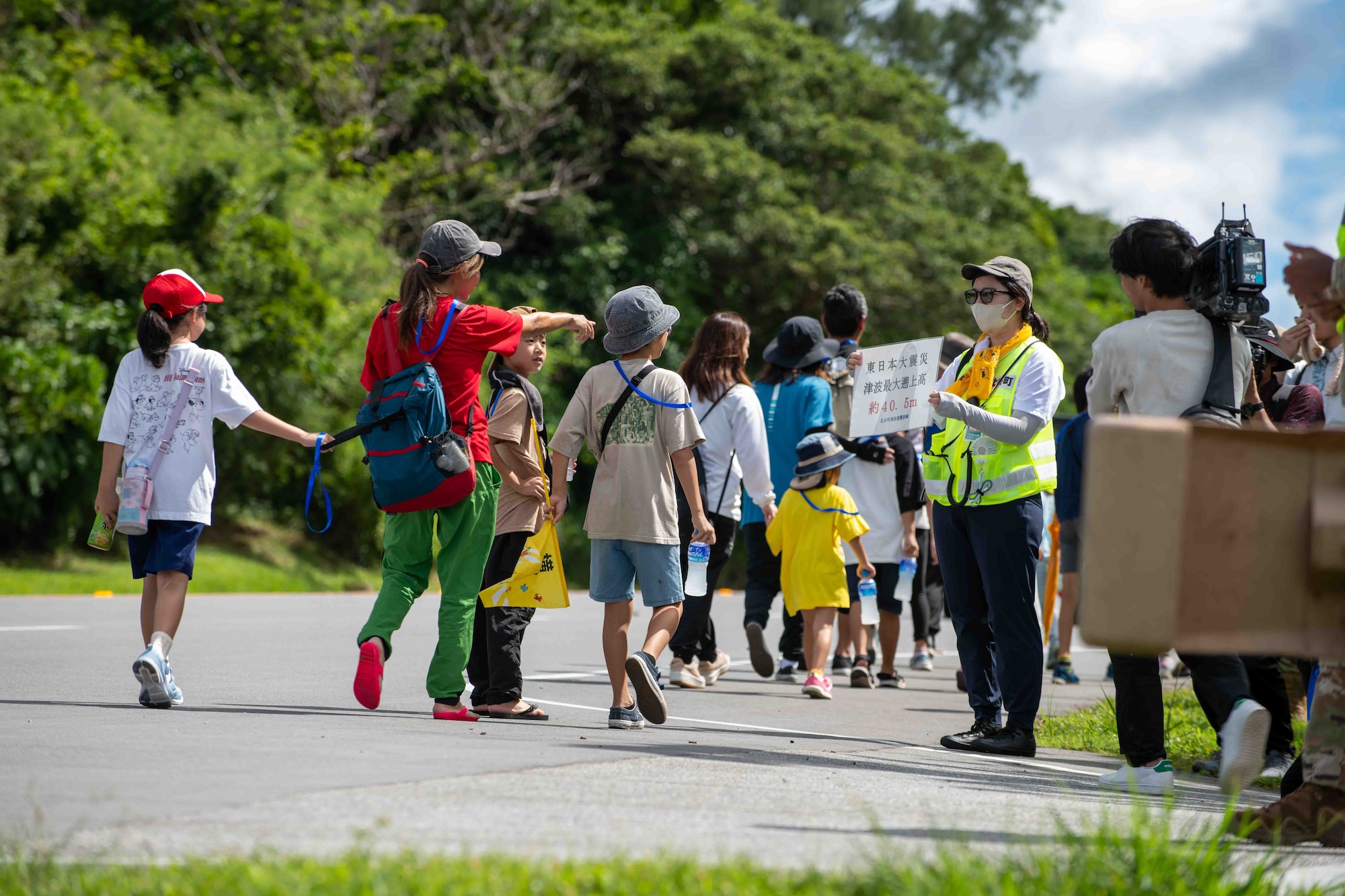 Japanese locals point at sea level signs while walking to higher ground