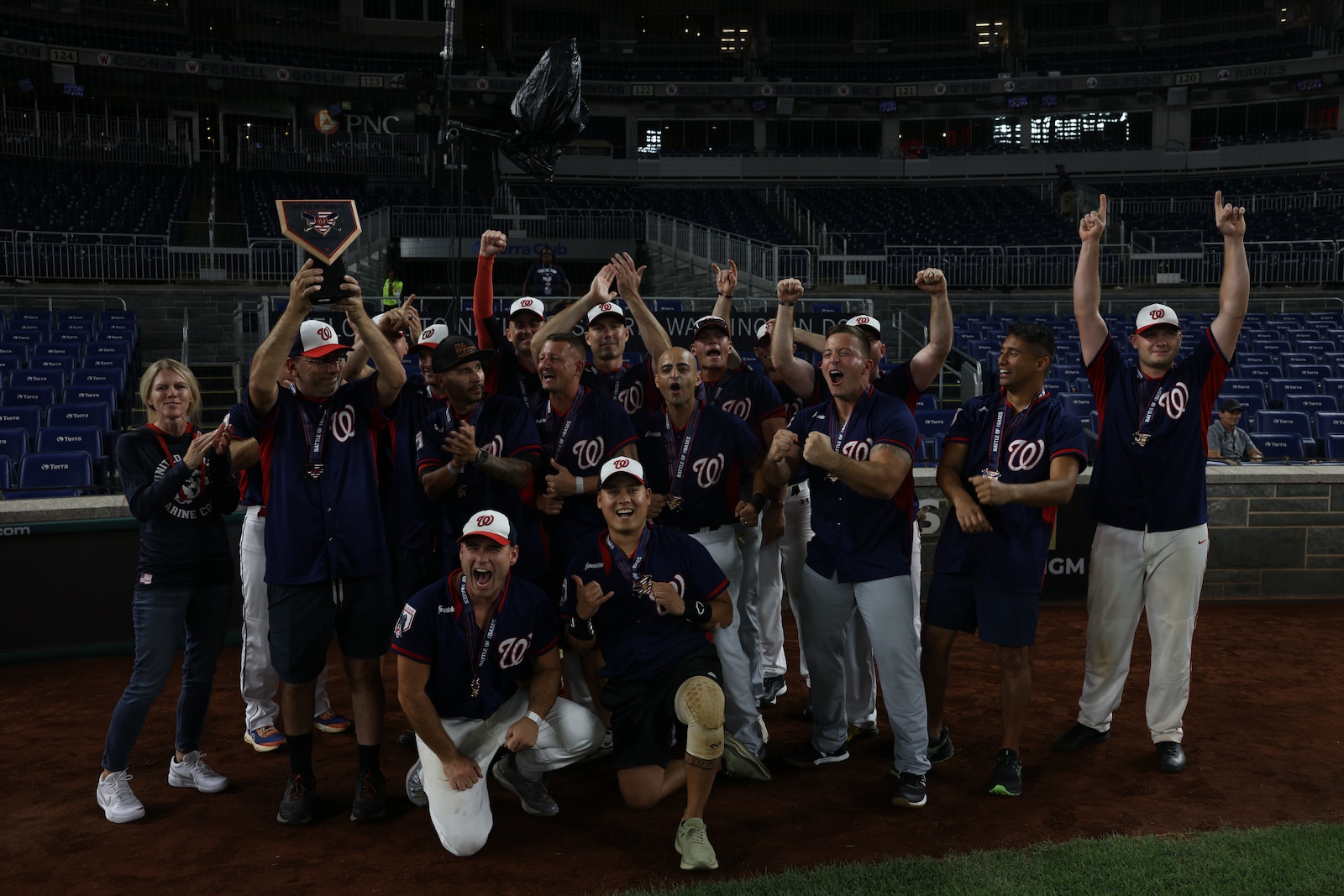 U.S. service members assigned to Marine Corps Base Quantico celebrate winning the Battle of the Bases, at Nationals Park, Washington, D.C., Sept. 14, 2024. This softball tournament, hosted by the Washington Nationals, brings together the best teams from military bases across the National Capital Region. (U.S. Marine Corps photo by Lance Cpl. Jeffery Stevens)