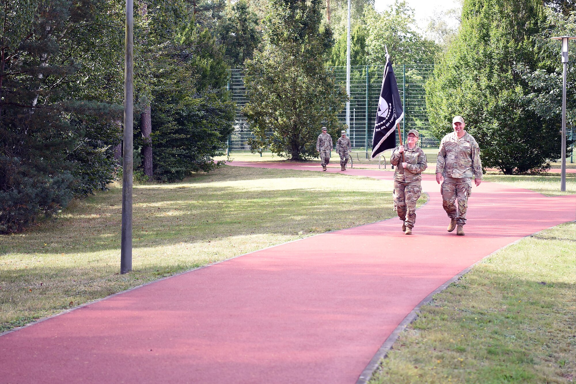 U.S. Air Force Brig. Gen. Adrienne L. Williams, 86th Airlift Wing commander, and Chief Master Sgt. Louis J. Ludwig, 86th AW command chief, complete the first lap with the POW/MIA flag, kicking off the 24-hour walk/run at Ramstein Air Base, Germany, Sept. 12, 2024
