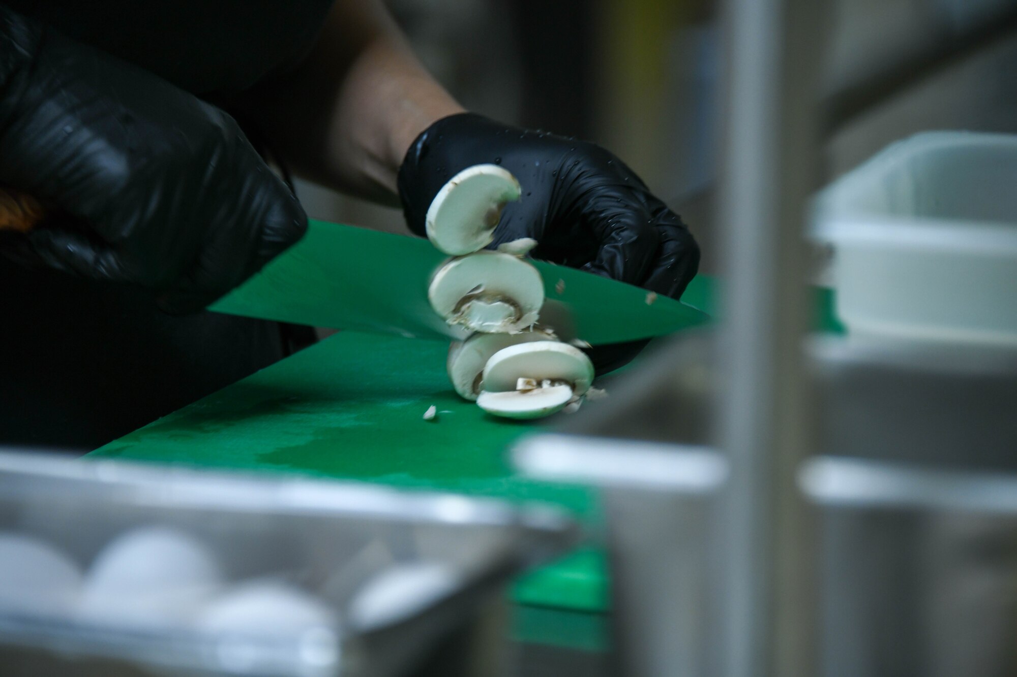 Cristene Balvino, cook, chops mushrooms at Altus Air Force Base, Oklahoma, Sept. 5, 2024. The Hangar 97 dining facility offers a variety of balanced, nutritious options that cater to different dietary needs. (U.S. Air Force photo by Senior Airman Miyah Gray)