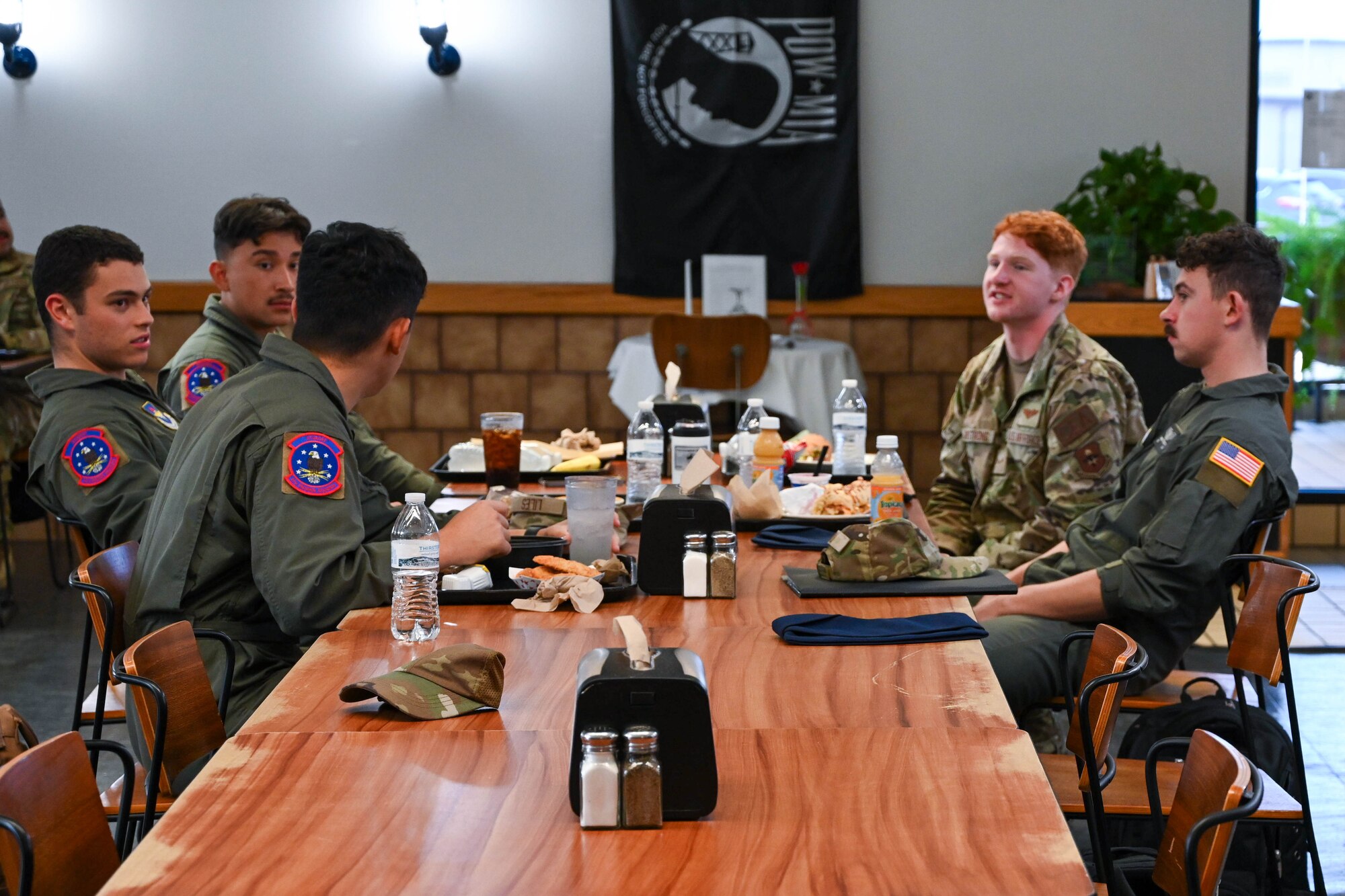 Airmen from the 97th Training Squadron have lunch at the Hangar 97 dining facility at Altus Air Force Base, Oklahoma, Sept. 6, 2024. The dining facility fosters comradery and allows Airmen opportunities to build connections. (U.S. Air Force photo by Senior Airman Miyah Gray)