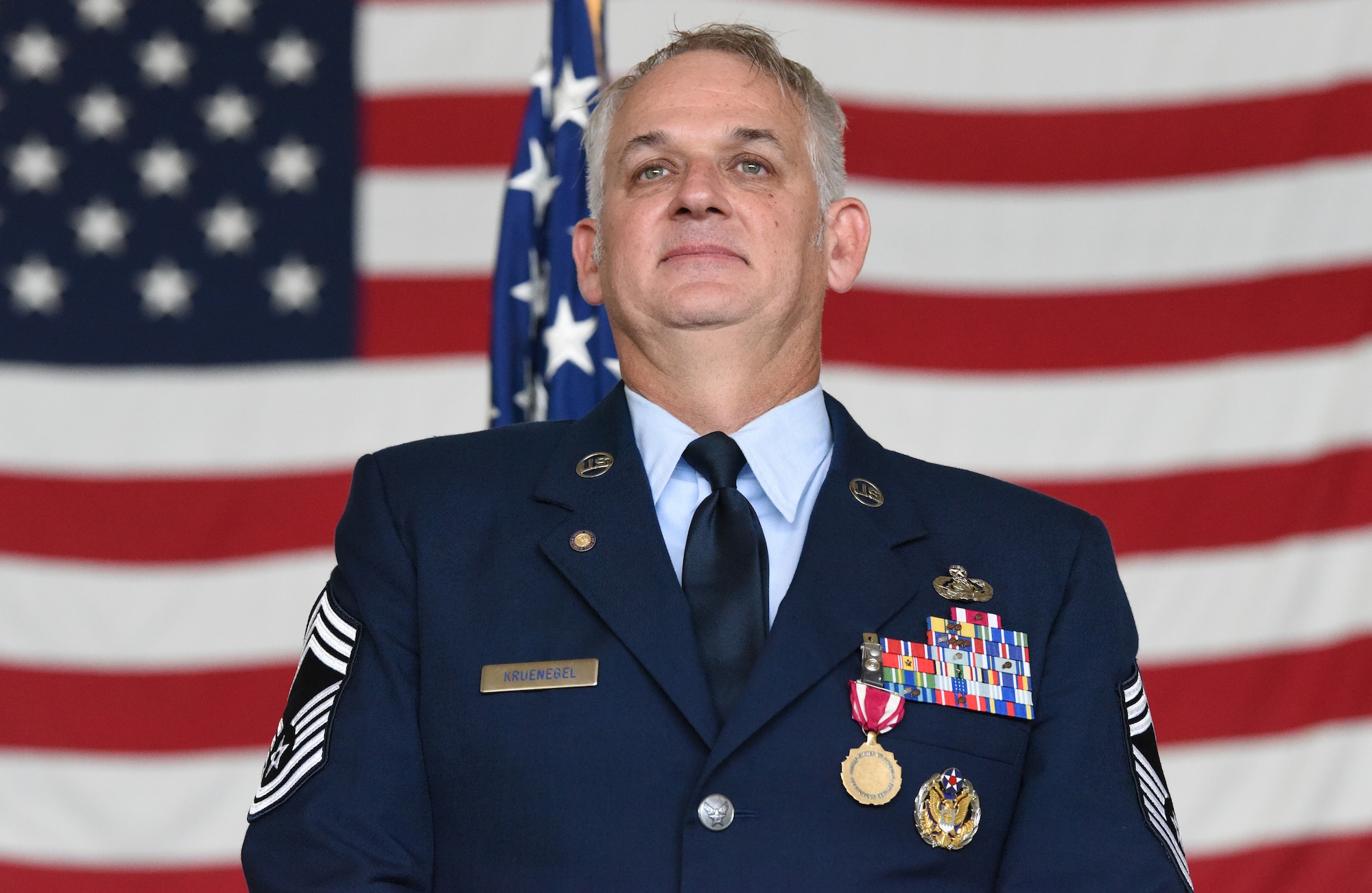 New York Air National Guard Chief Master Sgt. Jason Kruenegel, stands during his retirement ceremony at Francis .S. Gabreski Air National Guard Base in Westhampton Beach, New York, Sept. 6, 2024.
