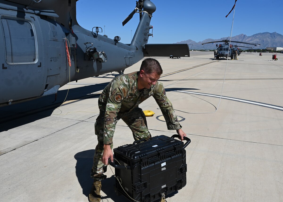 U.S. Air Force Staff Sgt. Shawn Bigger, 55th Rescue Generation Squadron mobility section noncommissioned officer in charge, demonstrates design flaws of current maintenance equipment, at Davis-Monthan Air Force Base, Arizona, Sept. 3, 2024. Bigger and his team developed a replacement toolkit called the tactical air combat portable all conditions kit (TAC-PACK), which simplifies transporting tools, saving manpower and exemplifying high-end readiness. (U.S. Air Force photo by Staff Sgt. Abbey Rieves)