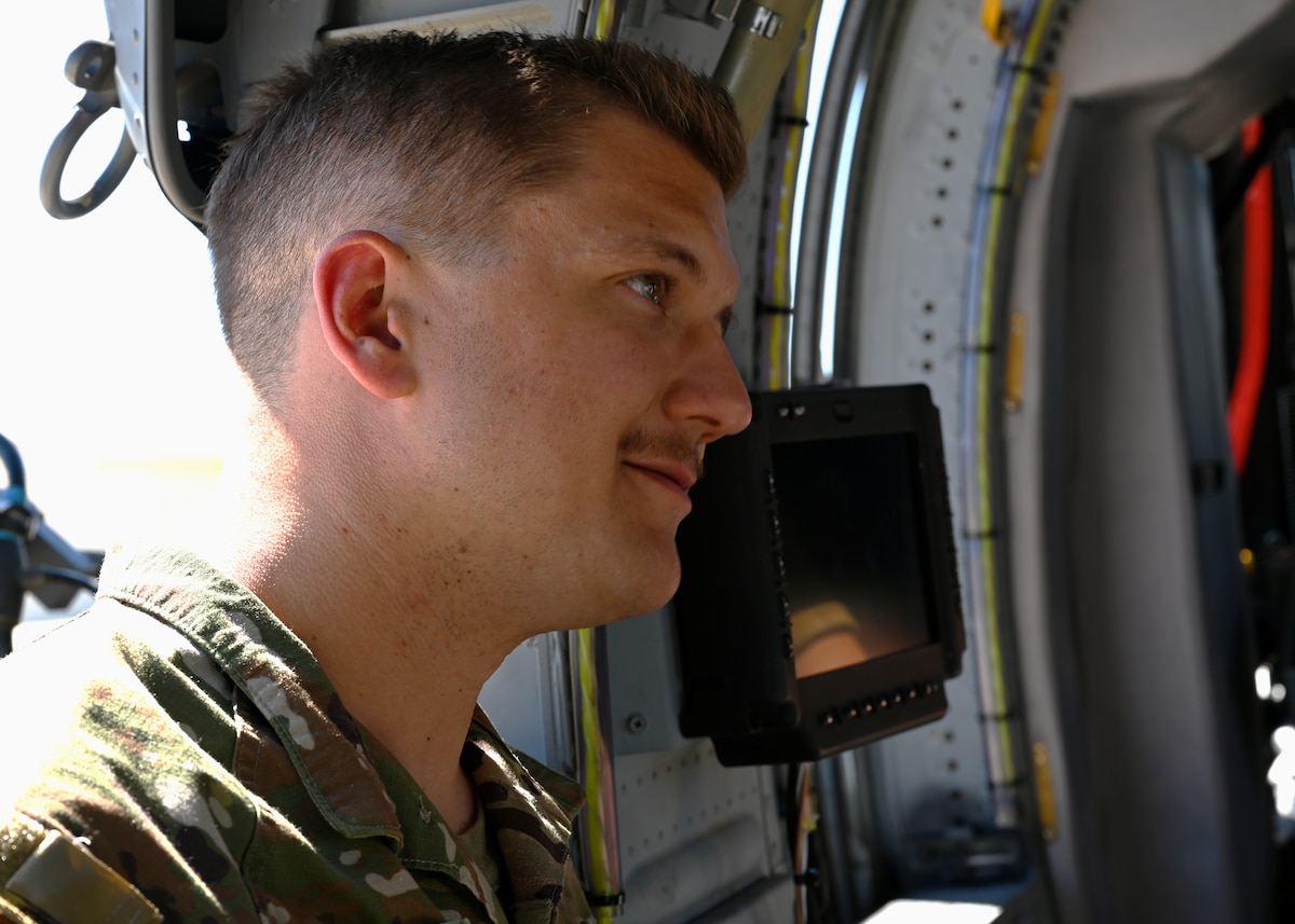 U.S. Air Force Staff Sgt. Shawn Bigger, 55th Rescue Generation Squadron mobility section noncommissioned officer in charge, looks inside an HH-60W Jolly Green II helicopter at Davis-Monthan Air Force Base, Arizona, Sept. 3, 2024.  Bigger developed a light-weight backpack-styled toolkit designed for portability in austere environments. (U.S. Air Force photo by Staff Sgt. Abbey Rieves)