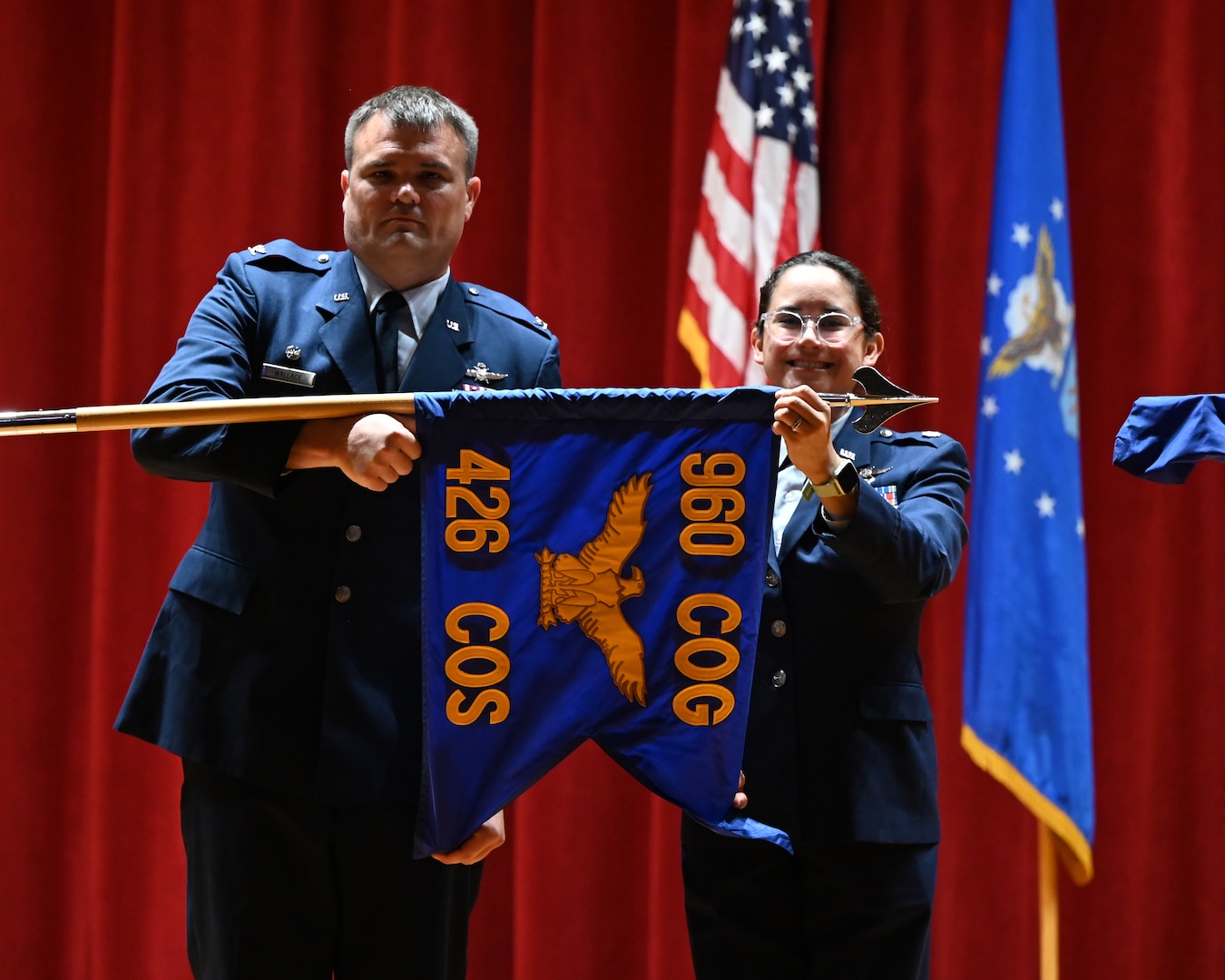 Col. Richard Wallace, 960th Cyberspace Operations Group commander, and Lt. Col. Cassandra Lee, incoming 426th Cyberspace Operations Squadron commander, unfurl the newly-designated 426 COS guidon during its redesignation ceremony at Joint Base San Antonio-Lackland, Texas on September 15th, 2024. (US Air Force photo by Alex Dieguez)