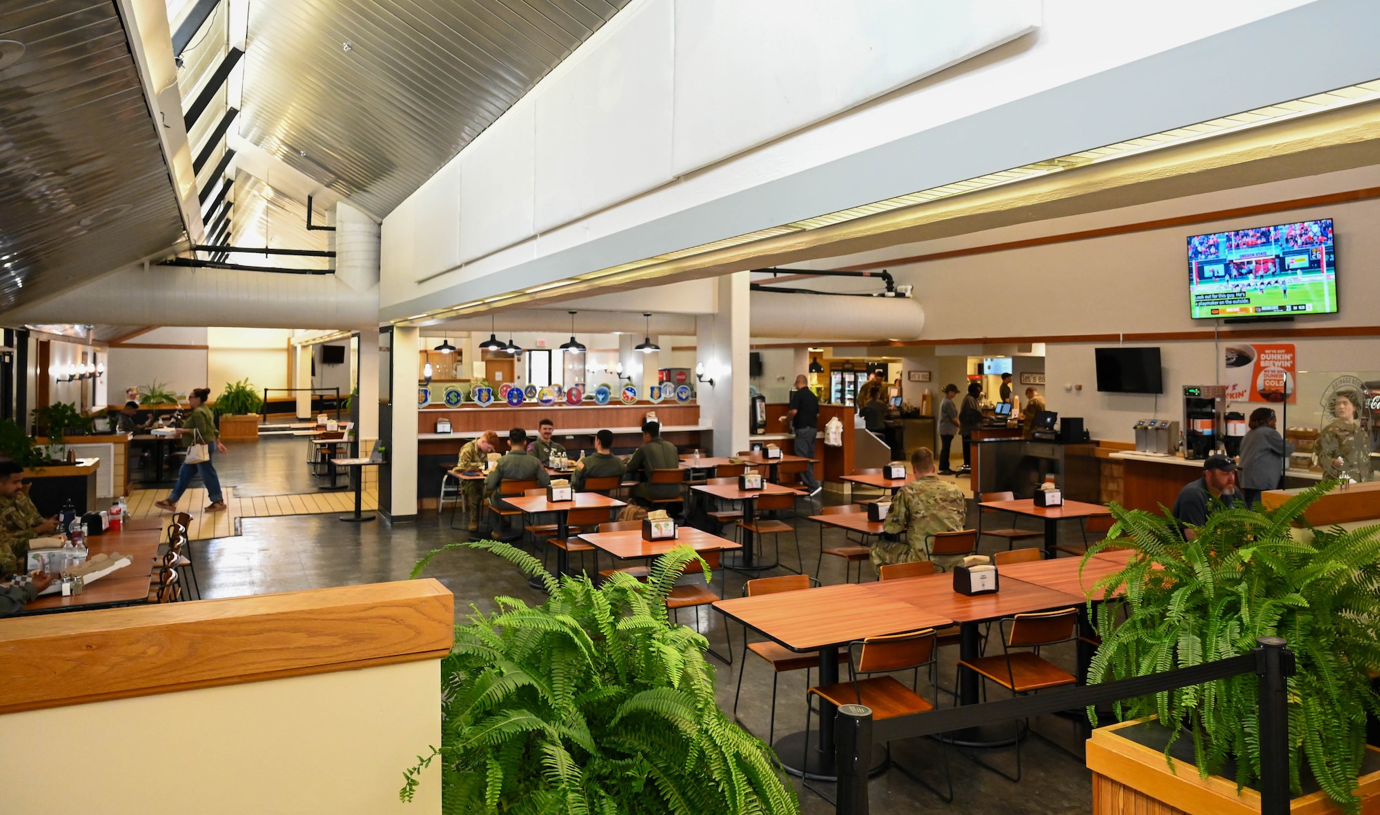 Airmen from the 97th Air Mobility Wing have lunch at the Hangar 97 dining facility at Altus Air Force Base, Oklahoma, Sept. 6, 2024. Hangar 97 was remodeled in 2022 with features including a new ventilation system and electrical units. (U.S. Air Force photo by Airman 1st Class Heidi Bucins)