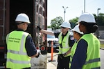 Four Coast Guard service members conducting container inspections