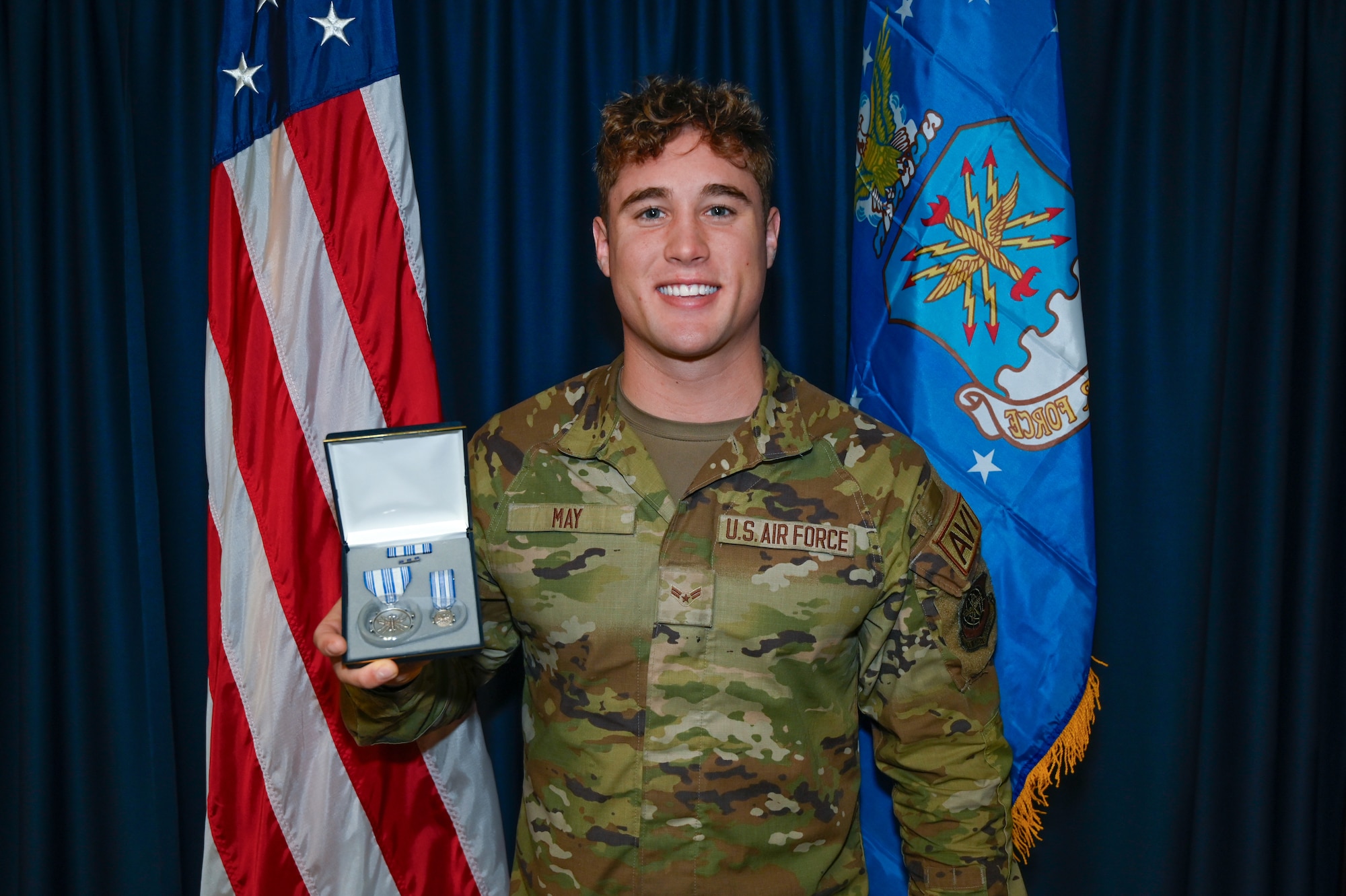 U.S. Air Force Airman 1st Class Troy May, 62d Aircraft Maintenance Squadron heavy aircraft integrated avionics specialist, holds his Air Force Achievement Medal at Joint Base Lewis-McChord, Washington, Sept. 13, 2024.