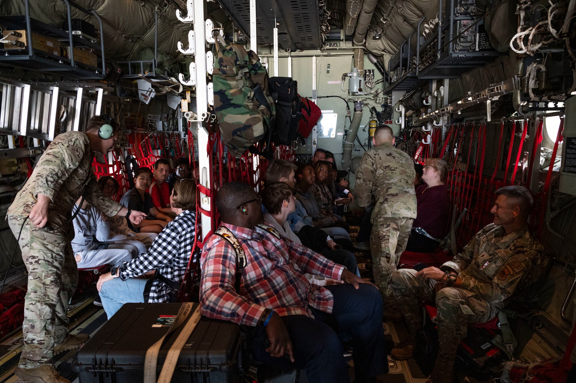 Airmen assigned to the 15th Special Operations Squadron hand out coins and patches to high school students from the greater Jackson, Mississippi area during an inspiration flight on an MC-130J Commando II near Jackson, Mississippi, Sept. 13, 2024.