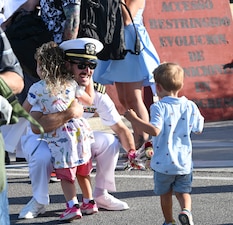 A Sailor from USS Roosevelt (DDG 80) reunites with his family at Naval Station Rota, Spain.