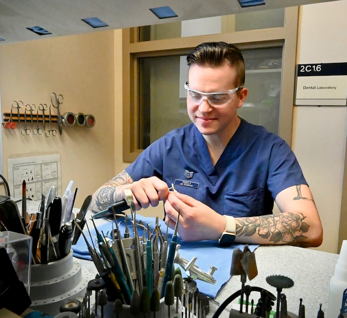 Air Force Tech. Sgt. Nicholas Panula works with a smile as he shapes a crown to perfection for a patient at the Los Angeles Air Force Base Dental Lab, El Segundo, CA.
