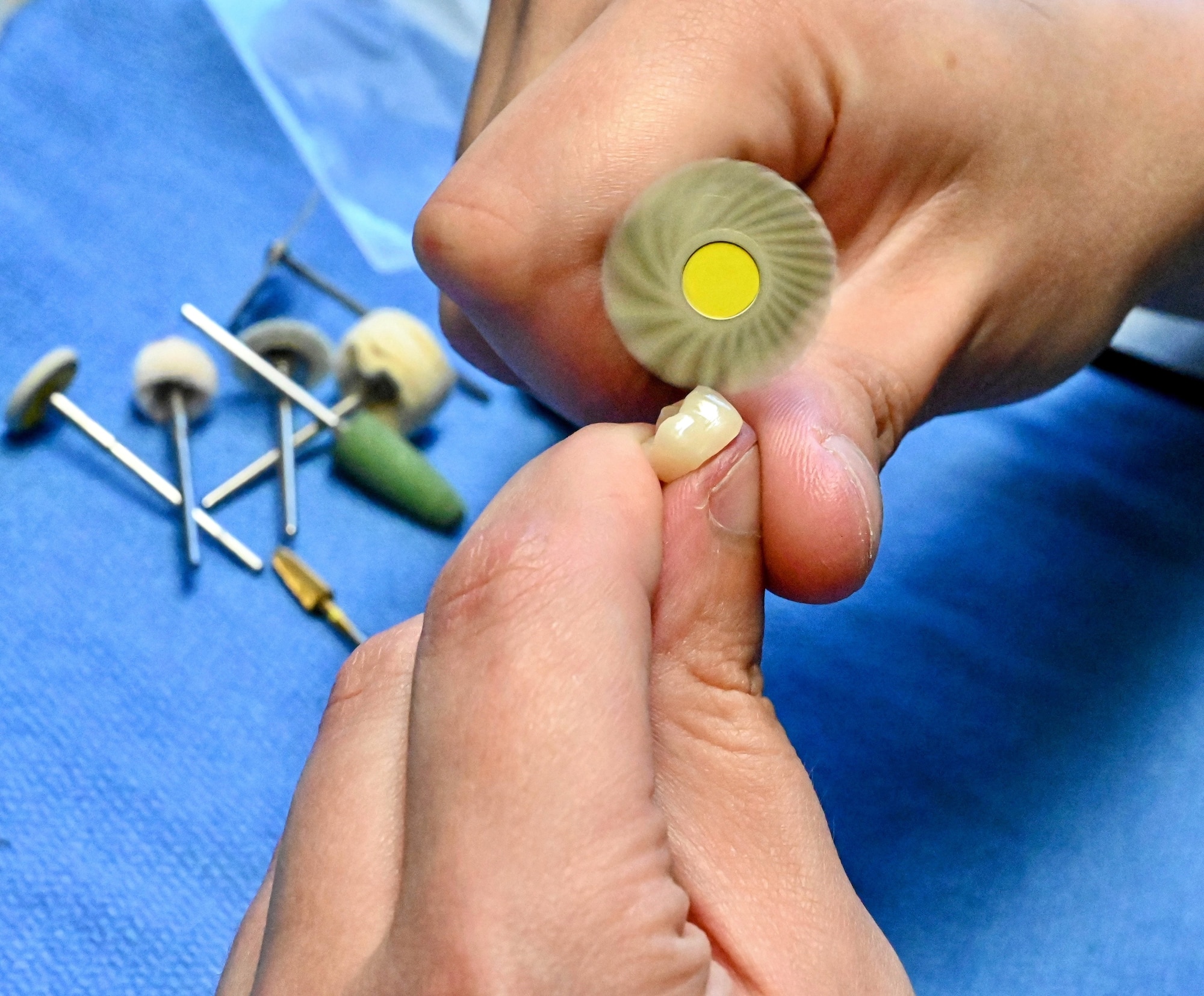 Air Force Tech. Sgt. Nicholas Panula, who recently earned his Dental Lab Certificate in crown and bridge, shapes a tooth to perfection for a patient at the Los Angeles Air Force Base, El Segundo, Calif.