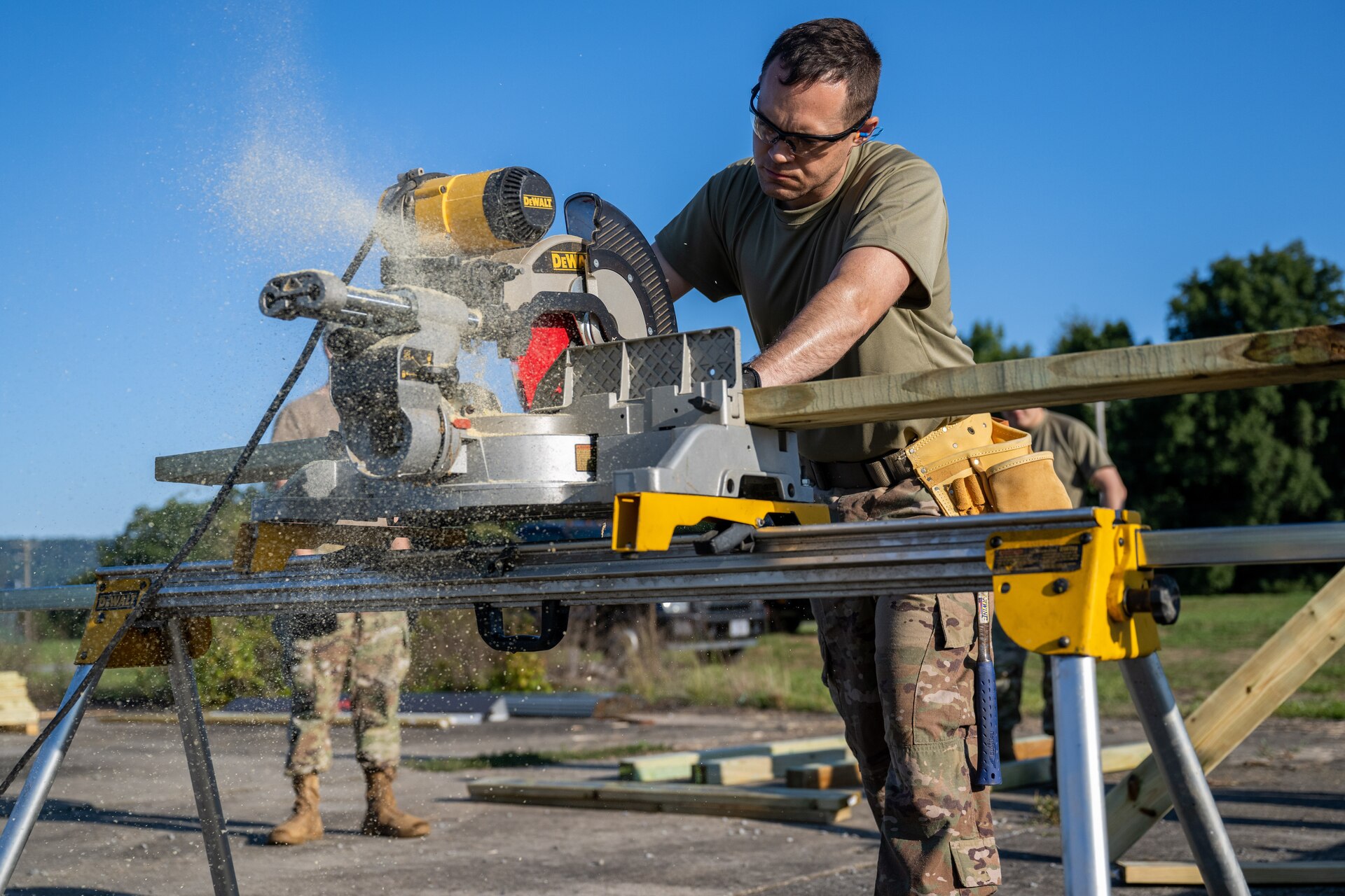 U.S. Air Force Tech. Sgt. Ronald Miller, 316th Civil Engineer Squadron structures noncommissioned officer in charge, operates a miter saw during a bivouac training exercise at Fort Indiantown Gap, Pa., Sept. 5, 2024. Structures Airmen were tasked with building a guard shack at a simulated remote forward base during the exercise. (U.S. Air Force photo by Airman 1st Class Daniel Walderbach)