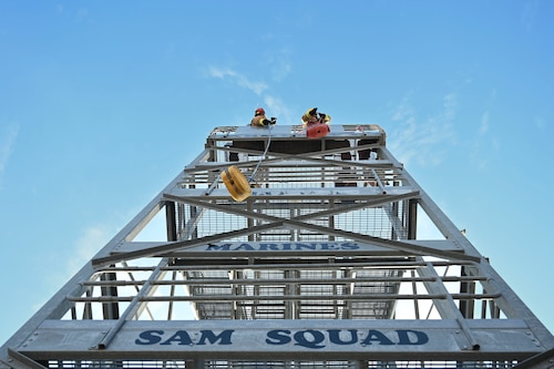Students assigned to the 312th Training Squadron hoist tools up the side of a five-story tower using rope during the 12th Annual Blood, Sweat & Stairs event at the Louis F. Garland Department of Defense Fire Academy, Goodfellow Air Force Base, Texas, Sept. 13, 2024. This obstacle represented hoisting tools up the side of a building during an active situation, training participants for rescue operations. Each obstacle in the combat challenge demonstrated different physical abilities that were pertinent to success of rescue operations carried out by first responders after 9/11. (U.S. Air Force photo by Airman 1st Class Madi Collier)