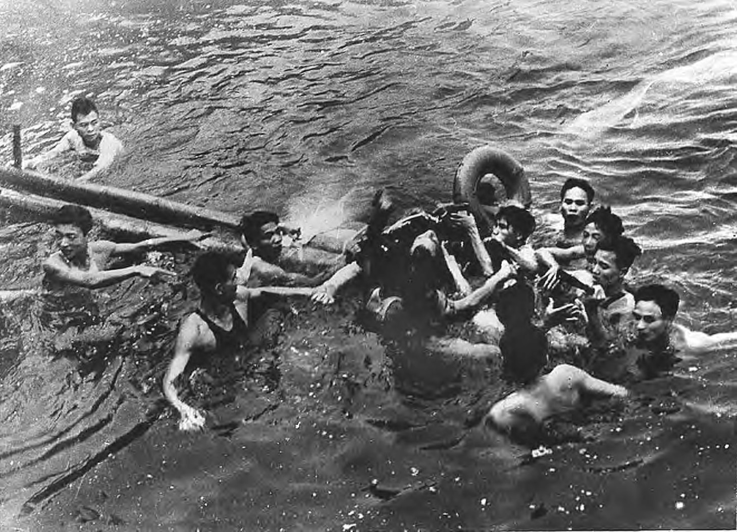 Vietnamese civilians surround Lt. Cmdr. John S. McCain, center, as he floats in Truc Bach Lake, in Hanoi, North Vietnam, after ejecting from his damaged aircraft, Oct. 26, 1967. He was pulled to shore, then transported to Hoa Lo Prison in Hanoi (Library of Congress).