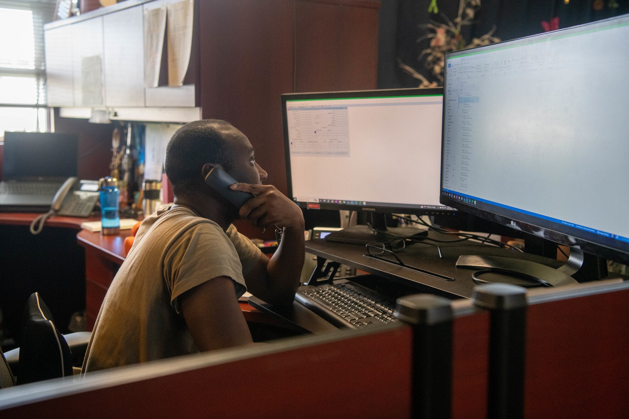 U.S. Air Force Staff Sgt. Mitchell Brown takes a call on the phone at 18th CPTS
