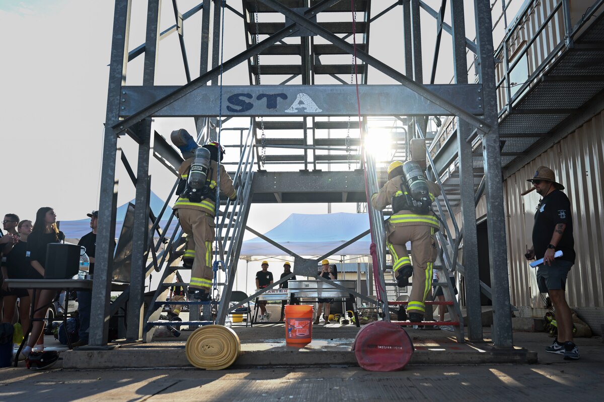 Members assigned to the 312th Training Squadron prepare to begin the first obstacle of the combat challenge during the 12th Annual Blood, Sweat & Stairs event at the Louis F. Garland Department of Defense Fire Academy, Goodfellow Air Force Base, Texas, Sept. 13, 2024. Participants climbed up a five-story tower while holding a hose. This obstacle was inspired by what first responders had to endure while carrying their equipment into the tower to extract survivors during 9/11. (U.S. Air Force photo by Airman 1st Class Madi Collier)