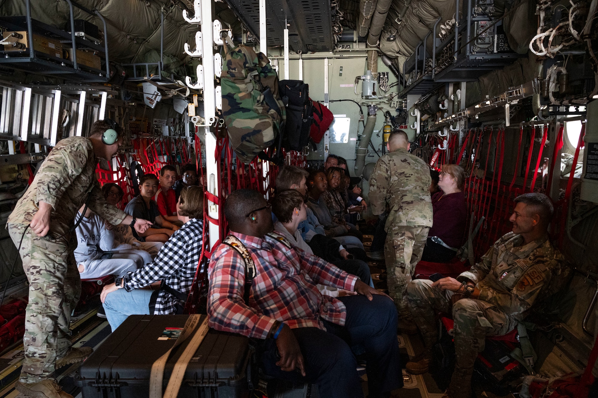 Airmen assigned to the 15th Special Operations Squadron hand out coins and patches to high school students from the greater Jackson, Mississippi area during an inspiration flight on an MC-130J Commando II near Jackson, Mississippi, Sept. 13, 2024.