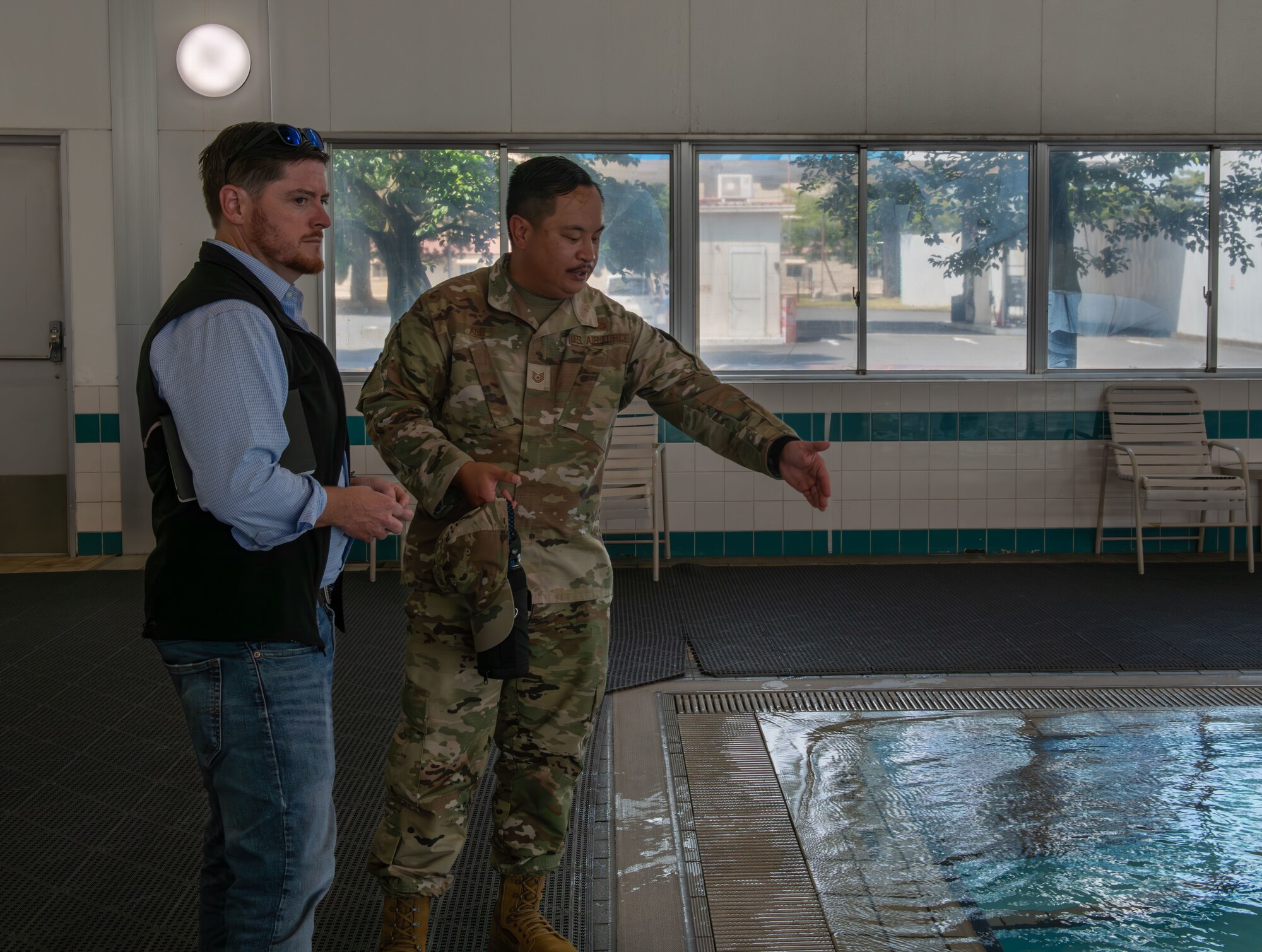 Honorable Brendan Owens stands in front of the pool as he receives a tour.