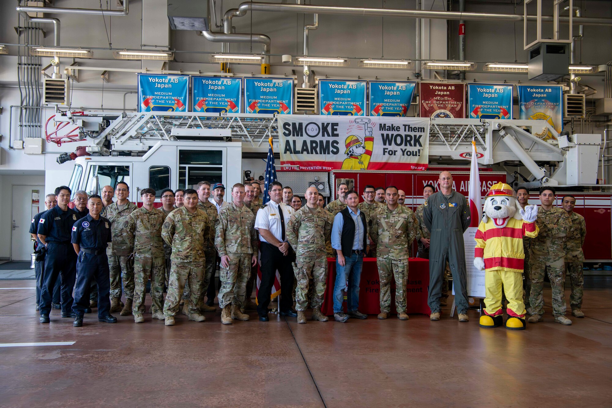Honorable Brendan Owens and Yokota Fire Departments members pose for a photo in front of a fire truck.