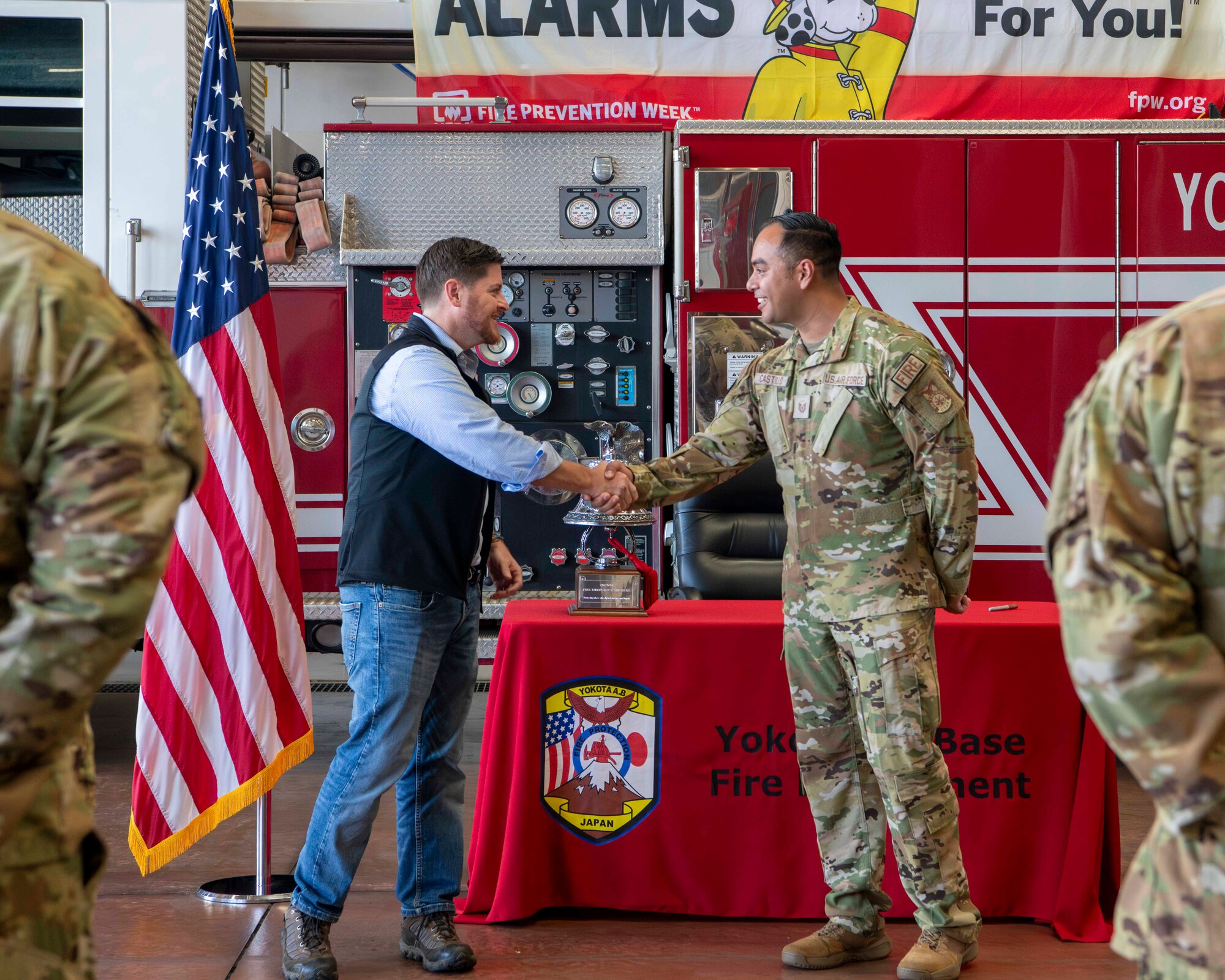 Honorable Brendan Owens coins a Yokota Fire Department member.