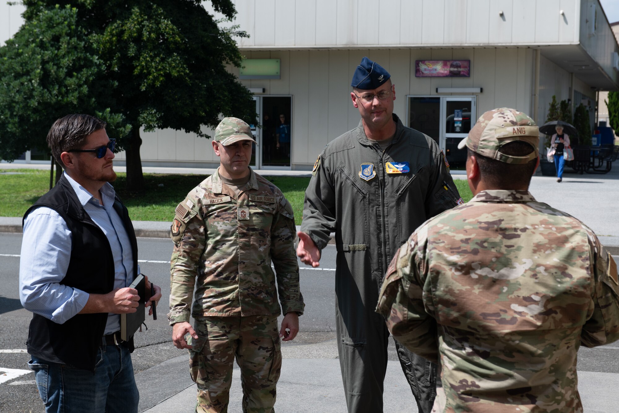 The 374th Airlift Wing commander speaks at a tour
