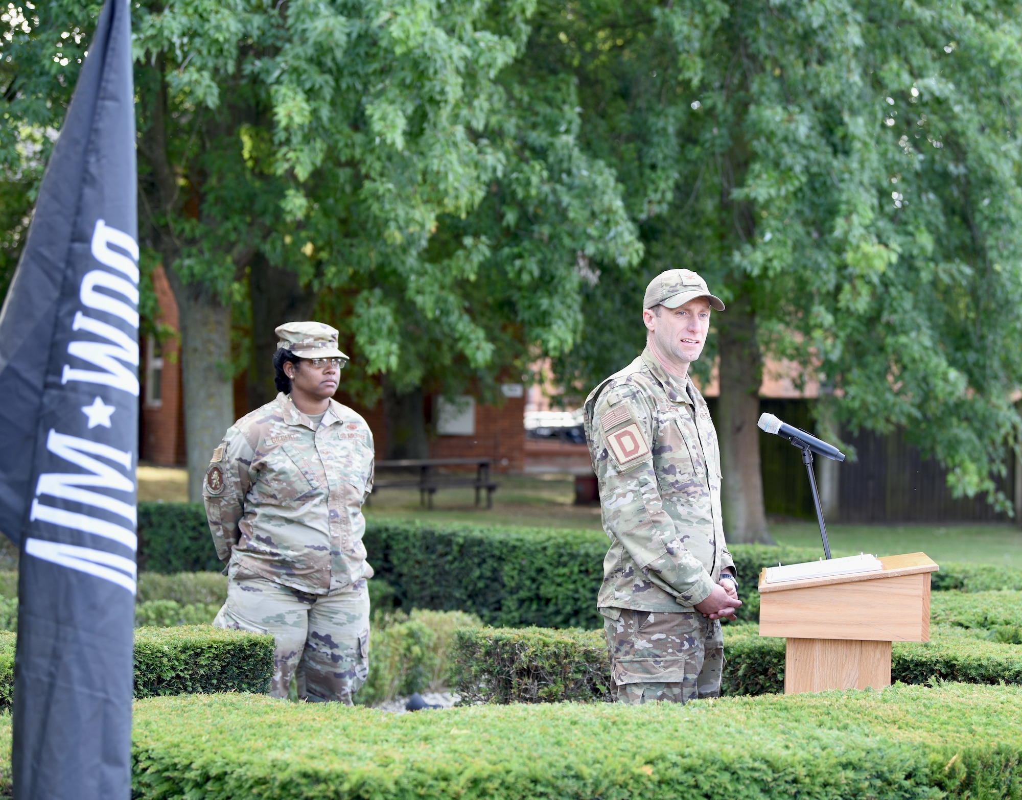 U.S. Col. Ryan Garlow, right, 100th Air Refueling Wing commander, gives closing remarks prior to the retreat ceremony concluding POW/MIA Week at Royal Air Force Mildenhall, England, Sept. 13, 2024. The week remembered and honored those Americans who were prisoners of war and those who served and never returned home. (U.S. Air Force photo by Karen Abeyasekere)