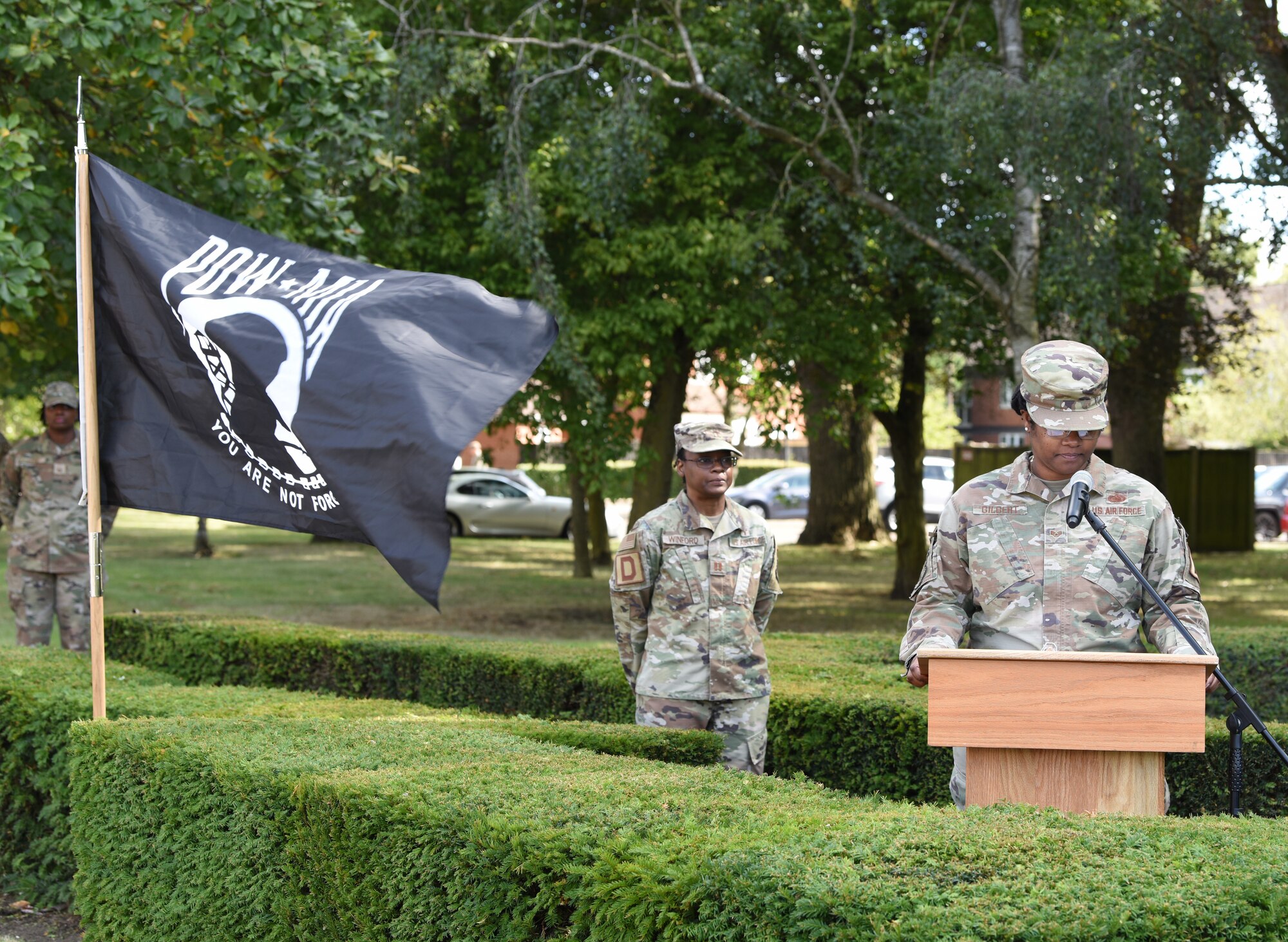 U.S. Staff Sgt. Aursula Gilbert, right, 100th Logistics Readiness Squadron, introduces Capt. Lavonia Winford, 100th Air Refueling Wing chaplain, before prayers are given prior to the retreat ceremony concluding POW/MIA Week at Royal Air Force Mildenhall, England, Sept. 13, 2024. The week remembered and honored those Americans who were prisoners of war and those who served and never returned home. (U.S. Air Force photo by Karen Abeyasekere)