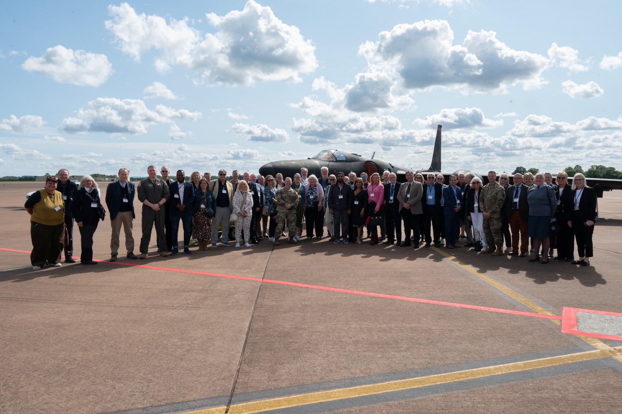 Pathfinders and civic leaders pose in front of a Lockheed U-2.