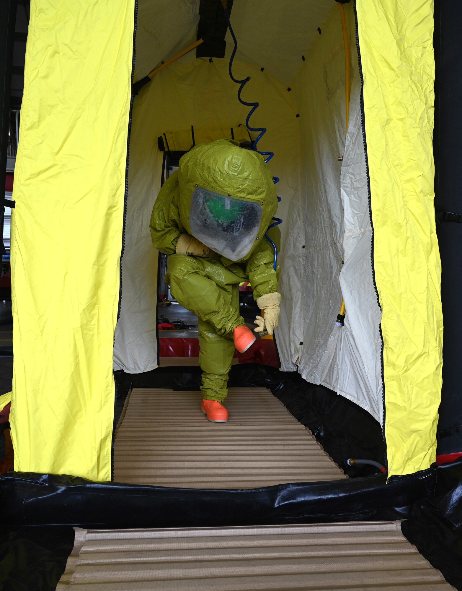 A rookie firefighter assigned to the 100th Civil Engineer Squadron Fire Department practices decontamination techniques during hazardous materials response training as part of “Rookie Academy” training at Royal Air Force Mildenhall, England, Aug. 27, 2024. The Rookie Academy is an intense training program where new rookie firefighters are trained together by different instructors within the fire department, so they learn equipment use and life-saving techniques the same way, rather than being split with different trainers. (U.S. Air Force photo by Karen Abeyasekere)